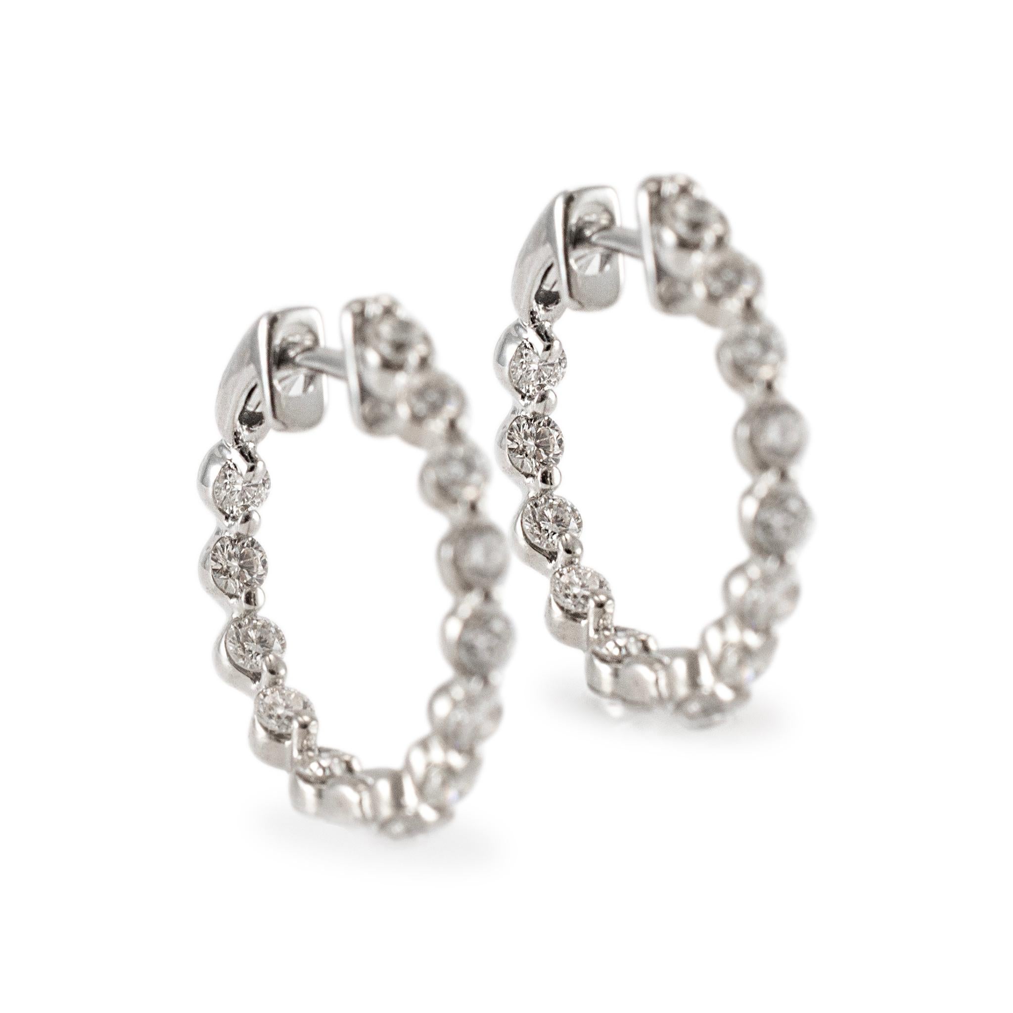 Gender: Ladies

Metal Type: 14K White Gold

Diameter: 18.80 mm

Weight: 3.44 grams

One pair of ladies 14K white gold diamond hoop earrings. The metal was tested and determined to be 14K white gold. Engraved with 