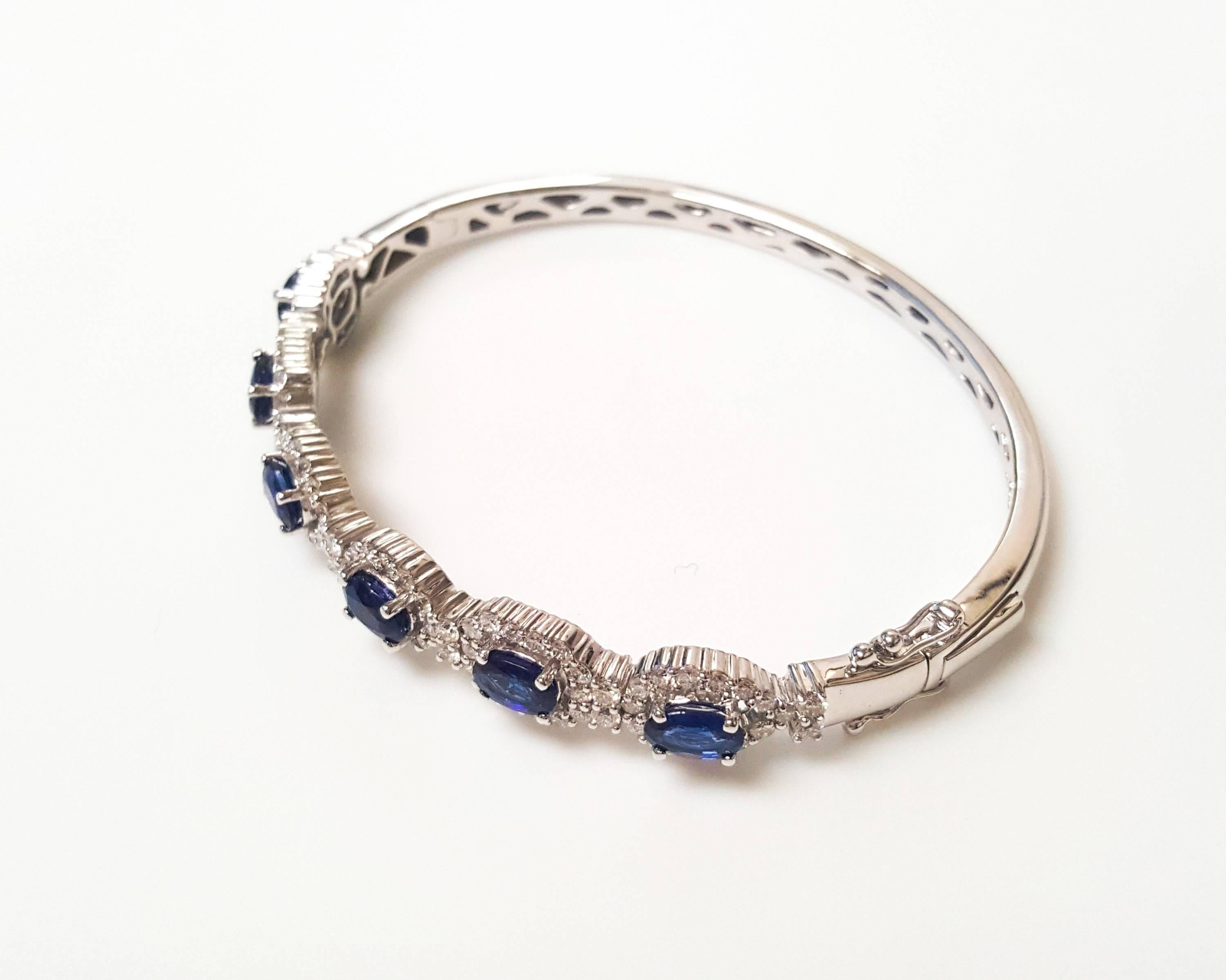 This Ladies 14k White Gold Bangle has 3.69 carats of perfectly Matched Sapphires and 1.62 carats of Diamonds.
