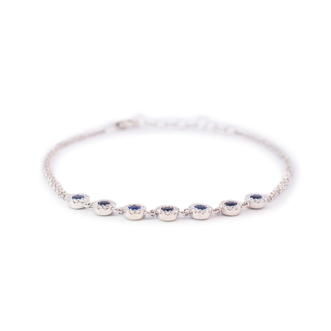 Gender: Ladies

Metal Type: 14K White Gold

Length: 6.50 inches

Width: 4.50mm tapering to 1.70mm

Weight: 2.83 grams

Diamond and sapphire link cocktail bracelet made from 14K white gold. This piece was polished and rhodium plated. Engraved with