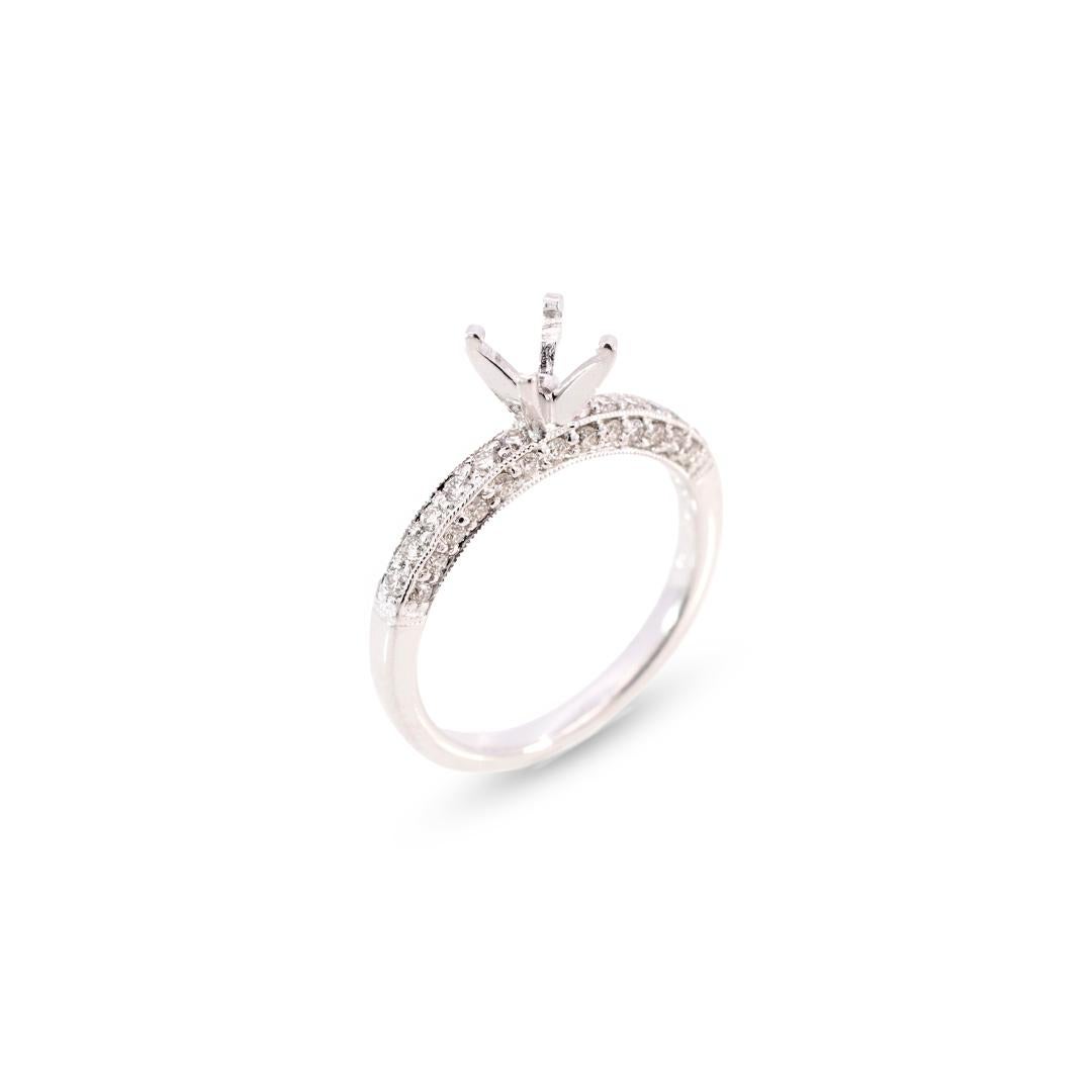 Ladies custom made polished rhodium plated 14K white gold, diamond engagement, semi-mount ring with a soft-square shank. The ring is a size 6.75, is 2.10mm thick and weighs a total of 2.88 grams.
Can Hold a center stone of Round or Cushion Cut Shape
