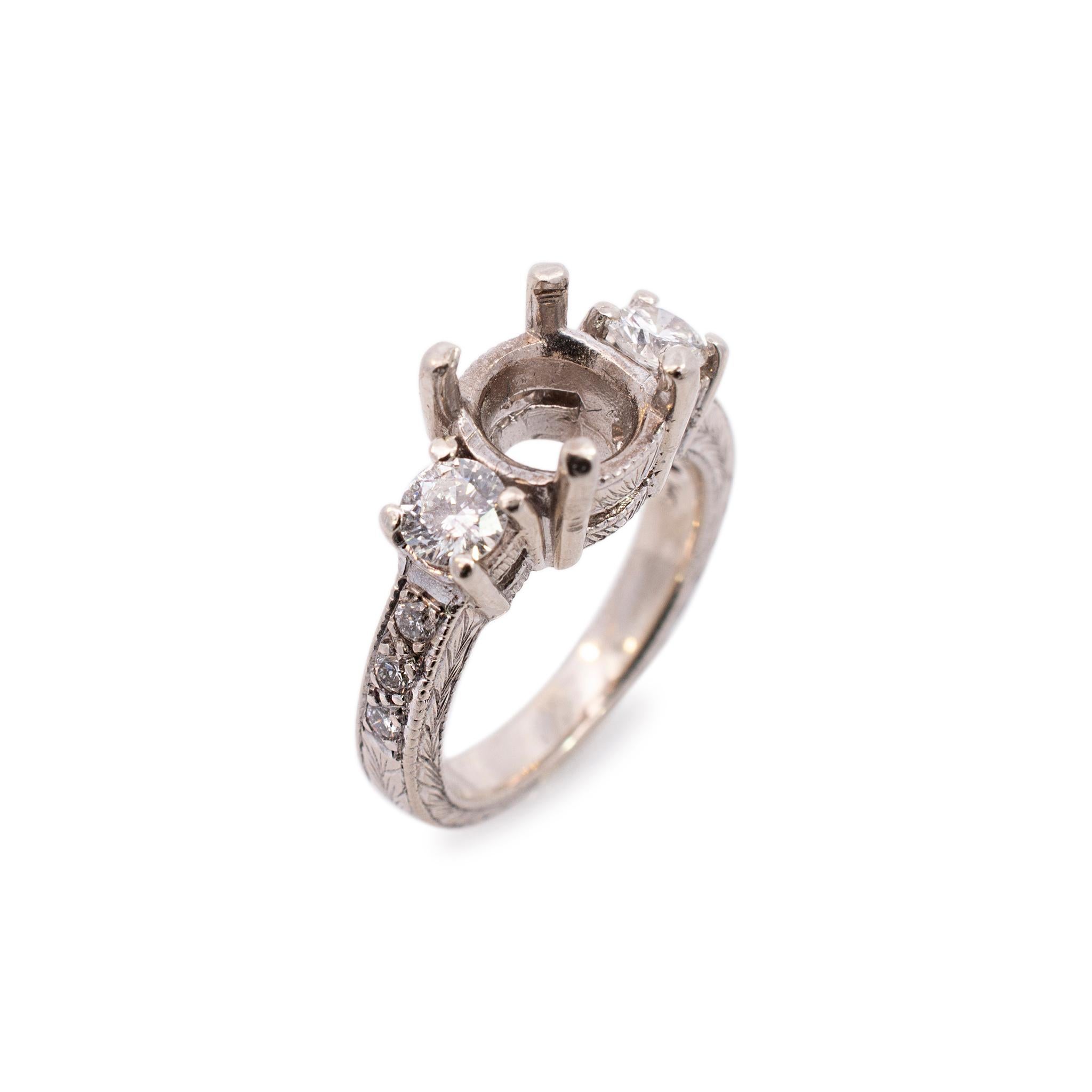 One lady's custom made textured & polished rhodium plated 14K white gold, diamond engagement, semi-mount ring with a soft-square shank. The ring is a size 4.5. The ring weighs a total of 5.60 grams. Engraved with 