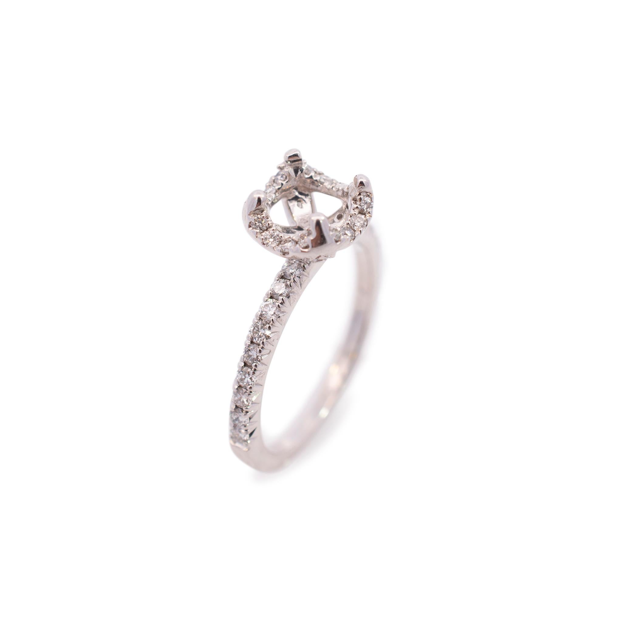Ladies custom-made polished rhodium plated 14K white gold, diamond engagement, semi-mount, halo ring with a half-round shank. The ring is size 6 and measures approximately 8.35mm tapering to 1.55mm in width and weighs a total of 2.86 grams. Engraved