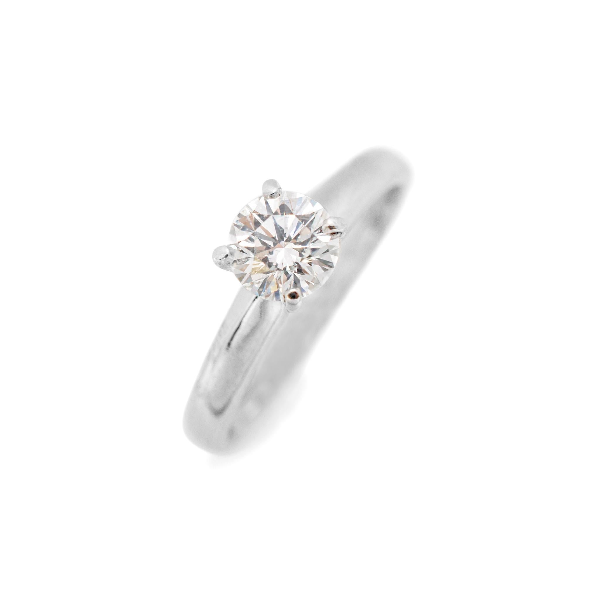 Gender: Ladies

Material: 14K White Gold

Size: 5

Shank Width: 2.70mm

Weight: 2.30 grams

Ladies 14K white gold diamond solitaire engagement ring with a half round shank. Engraved with 