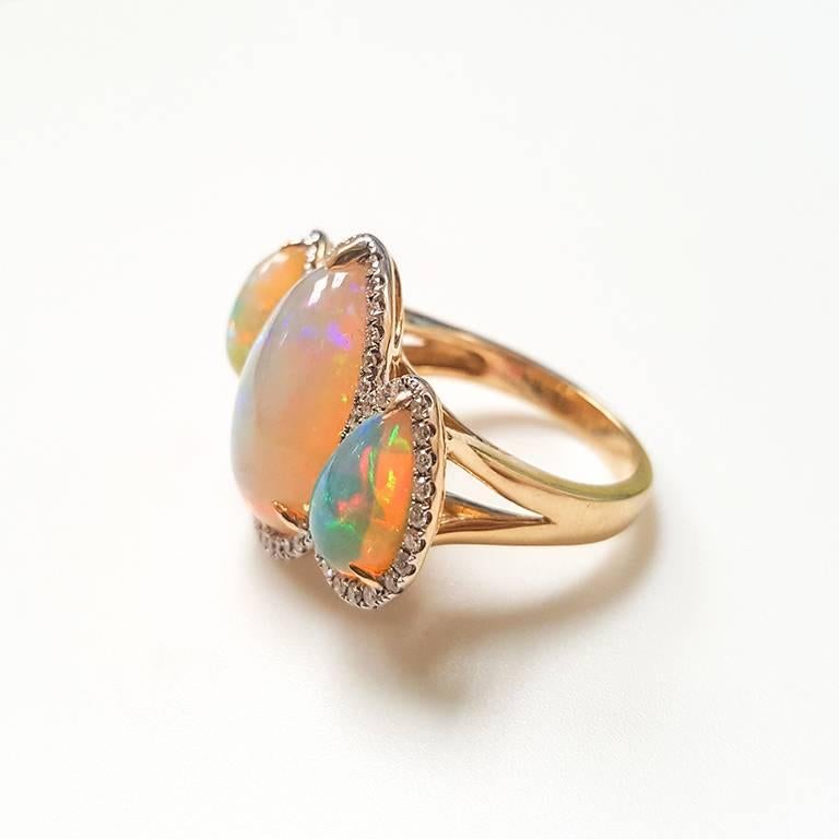 This Ladies 14k Yellow Gold Ethiopian Opal and Diamonds Ring has 7.86 carats of perfectly Matched Opal and 0.45 carats of Diamonds. 
