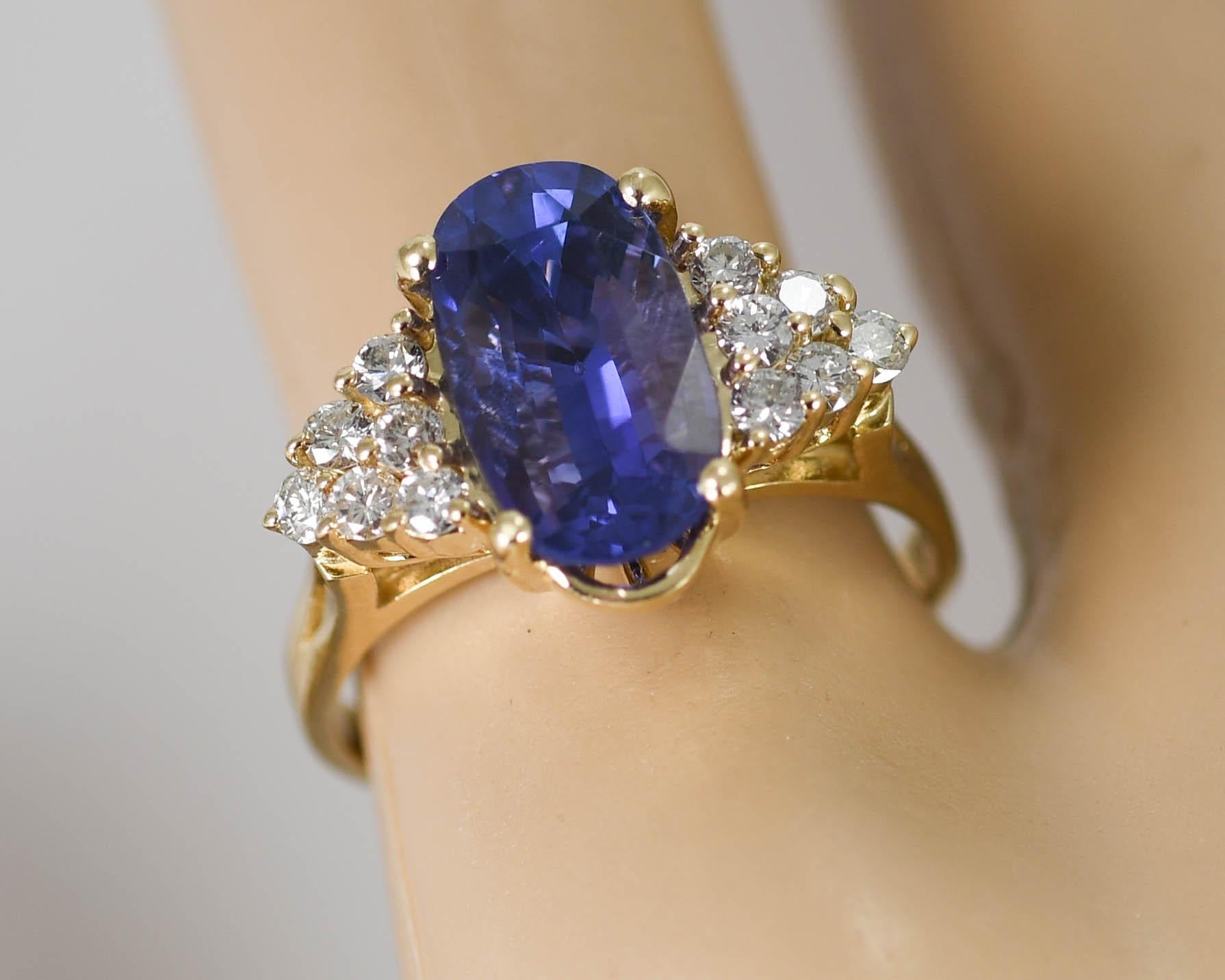 Ladies violet-blue sapphire and diamond ring in 14k yellow gold setting.
Stamped 14k and weighs 4.9 grams.
The oval sapphire weighs 4.86 carats,  modified brilliant cut.
The color is an excellent violet-blue color, no heat treatment.
The GIA grading