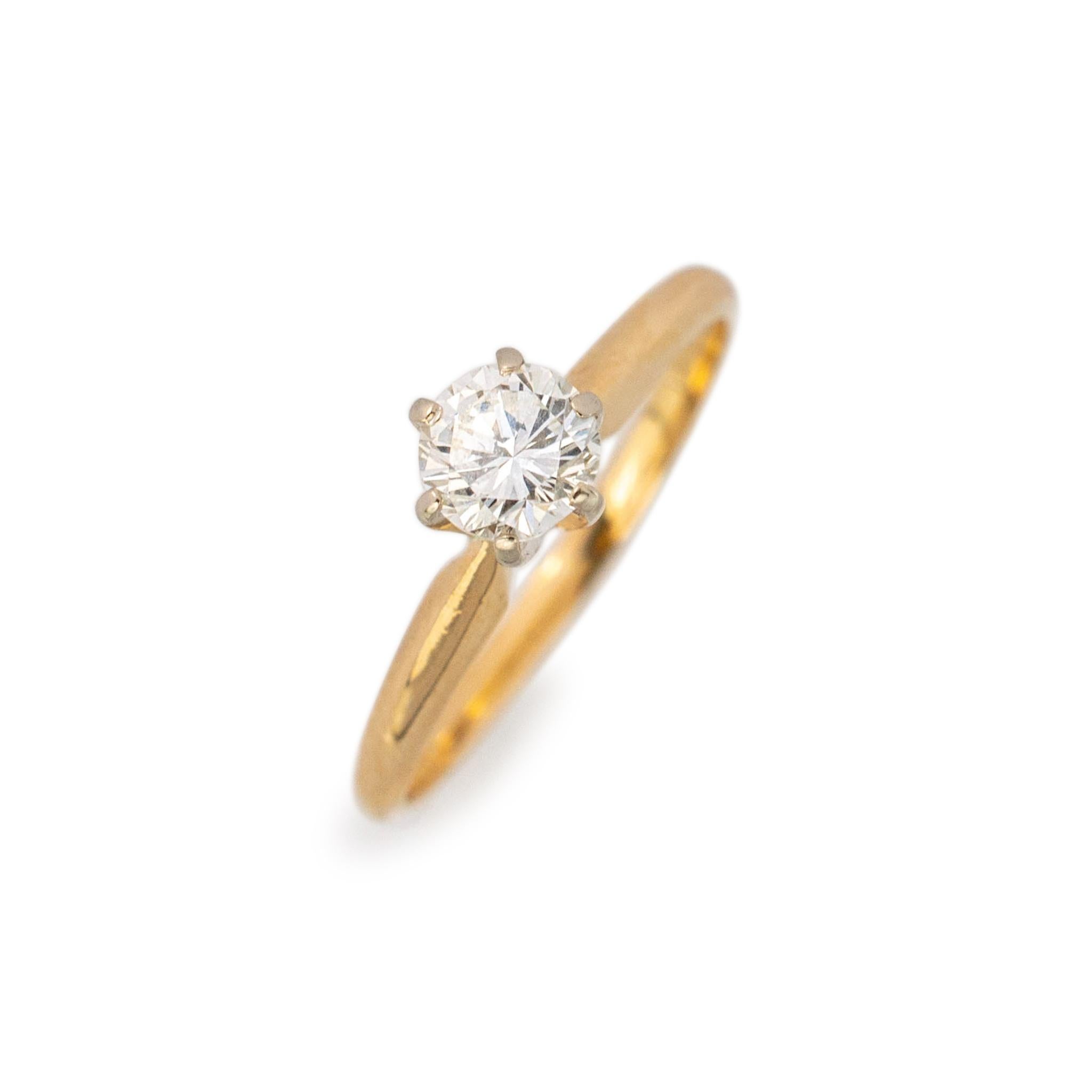 Gender: Ladies

Metal Type: 14K Yellow Gold

Size: 7

Shank Width: 2.25mm

Weight: 2.00grams

Ladies 14K yellow gold diamond solitaire engagement ring with a half round shank.
Engraved with 