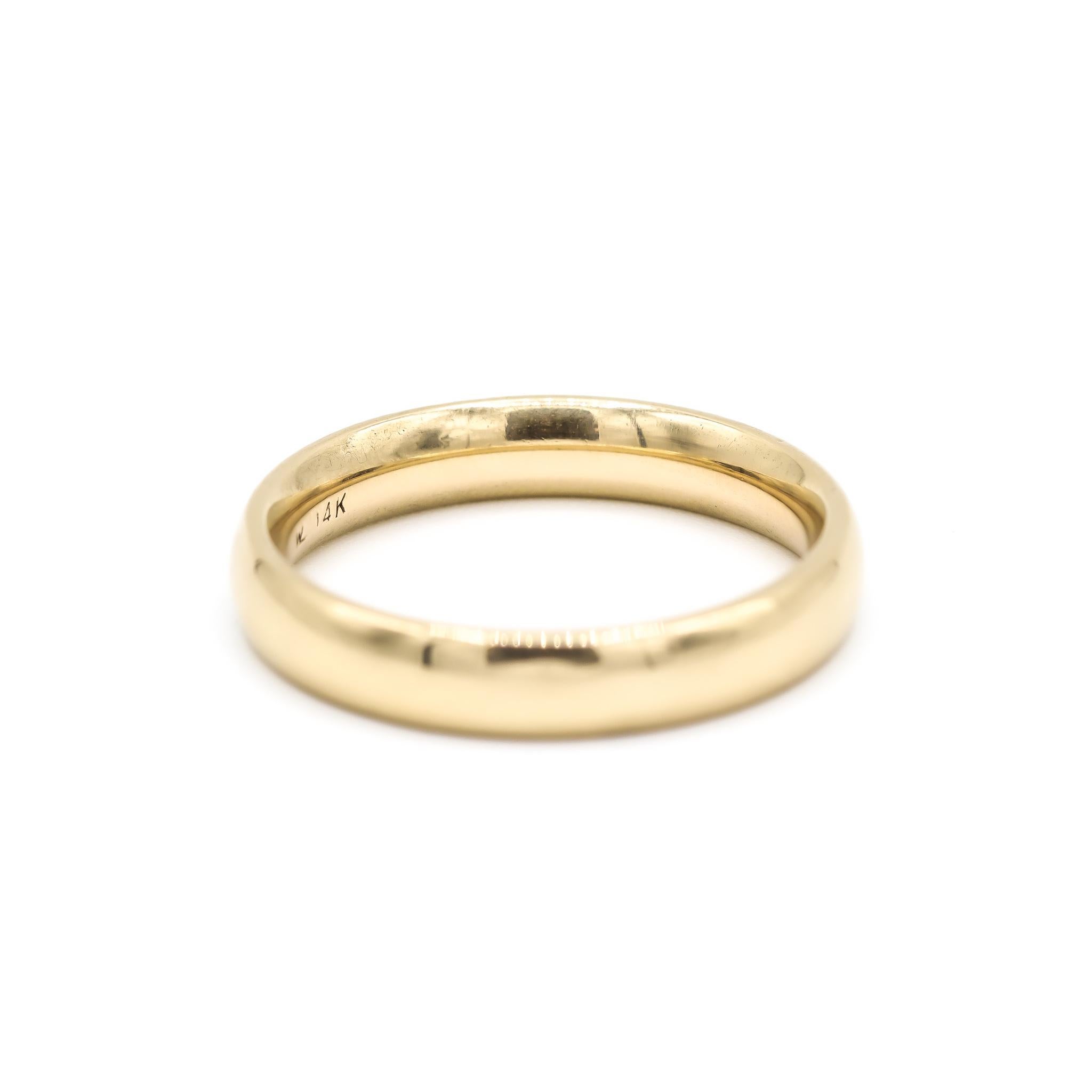 One lady's custom made polished 14K yellow gold, wedding band with a half-round shank. The band is a size 8.75. The band weighs a total of 5.40 grams. Engraved with 