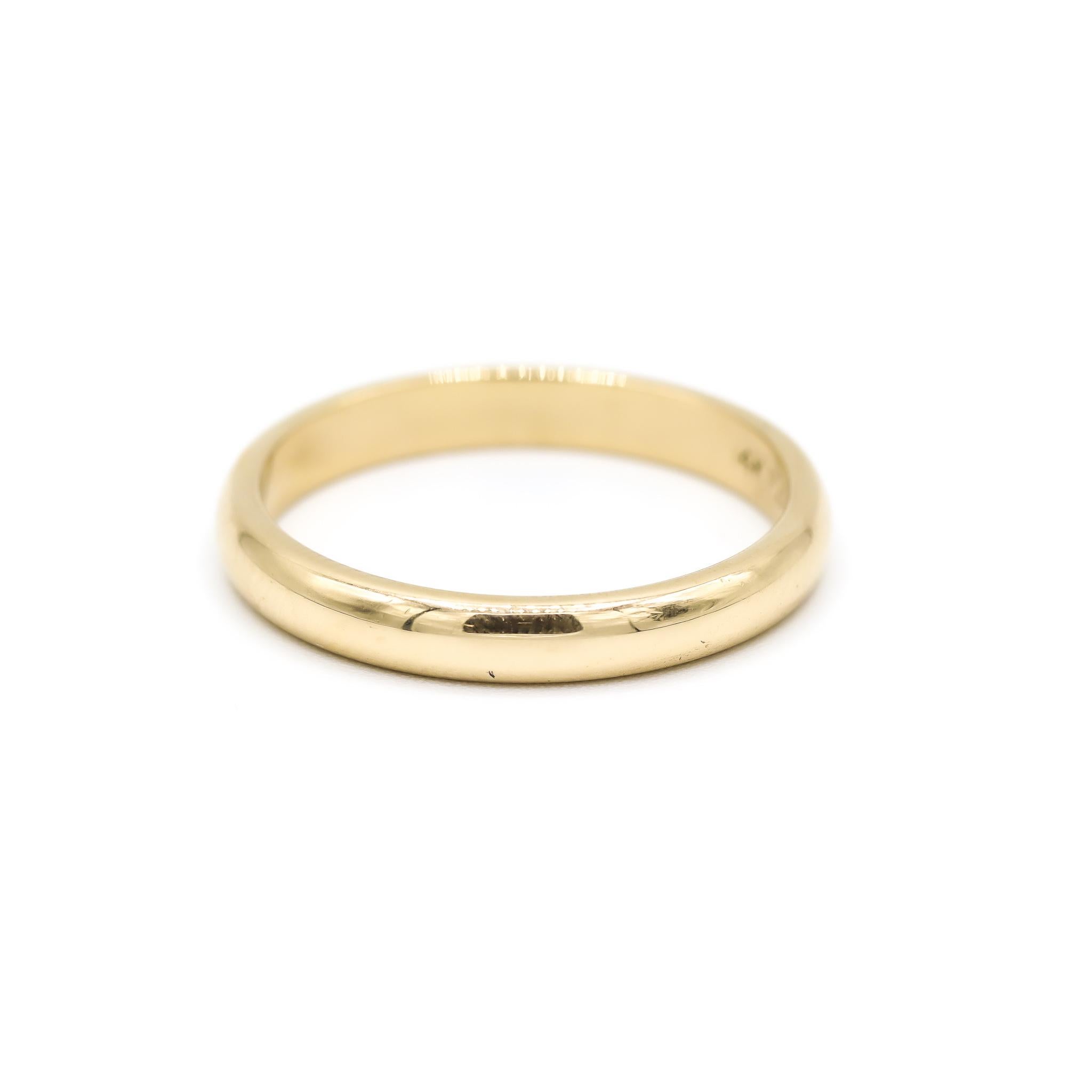 One lady's custom made polished 14K yellow gold, wedding band with a half-round shank. The band is a size 7.5. The band weighs a total of 3.10 grams. Engraved with 