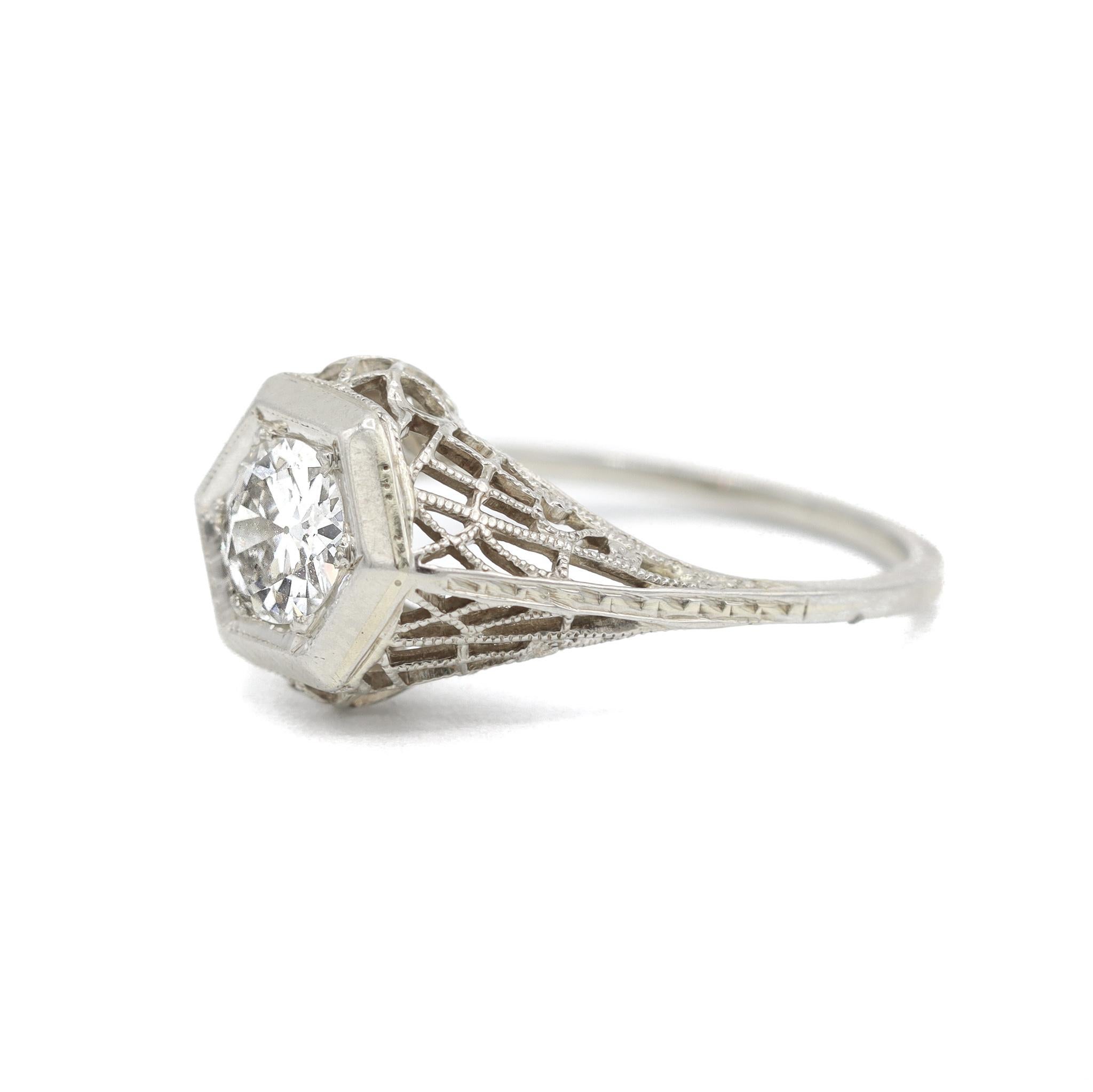 One lady's hand made hand engraved, textured 18K white gold, diamond engagement, vintage, antique, art-deco, solitaire engagement ring with a half round shank. The ring is a size 6.25. The ring weighs a total of 2.60 grams. Engraved with 