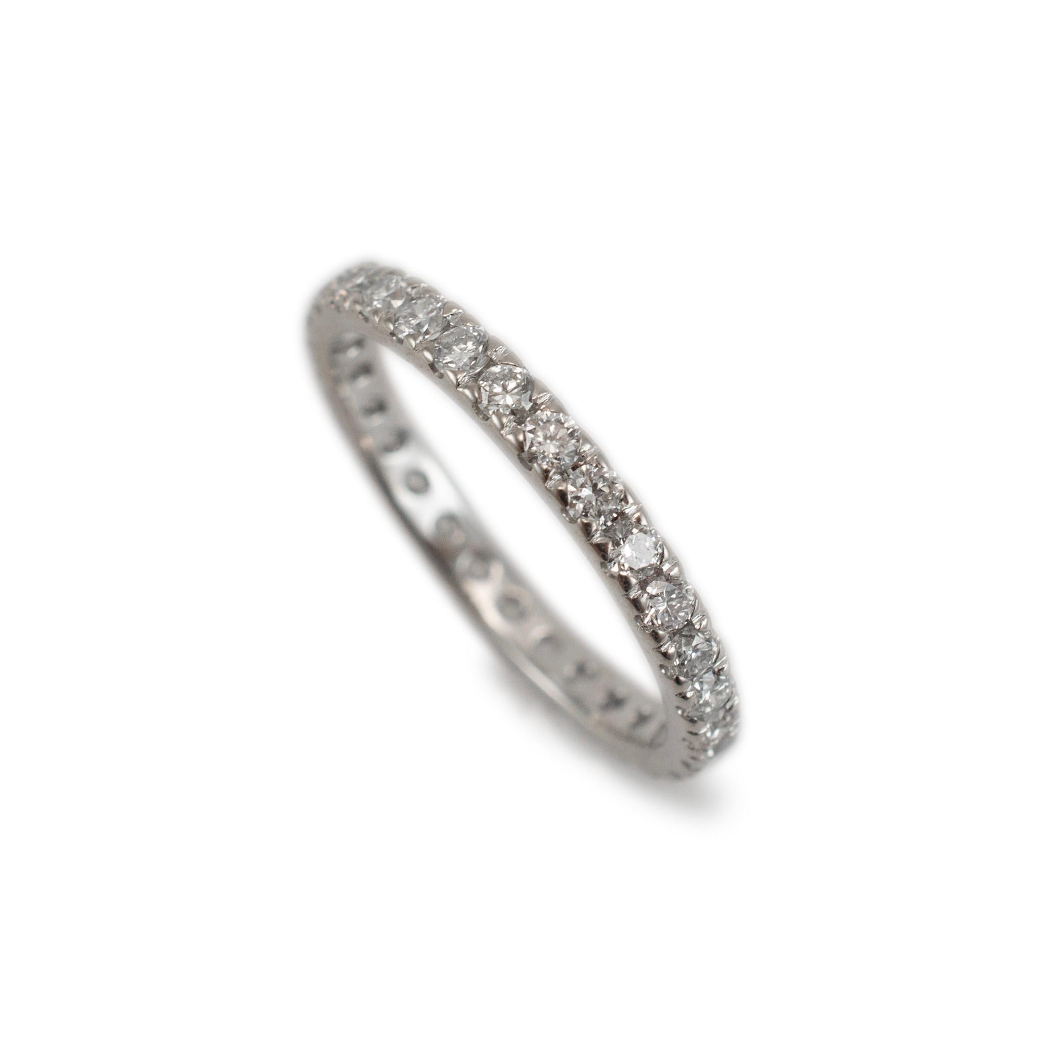 Gender: Ladies

Metal Type: 18K White Gold

Size: 6

Width: 2.20 mm

Weight: 1.89 Grams

One ladies custom made polished 18K white gold, diamond wedding, eternity band with a half-round shank. The metal was tested and determined to be 18K white