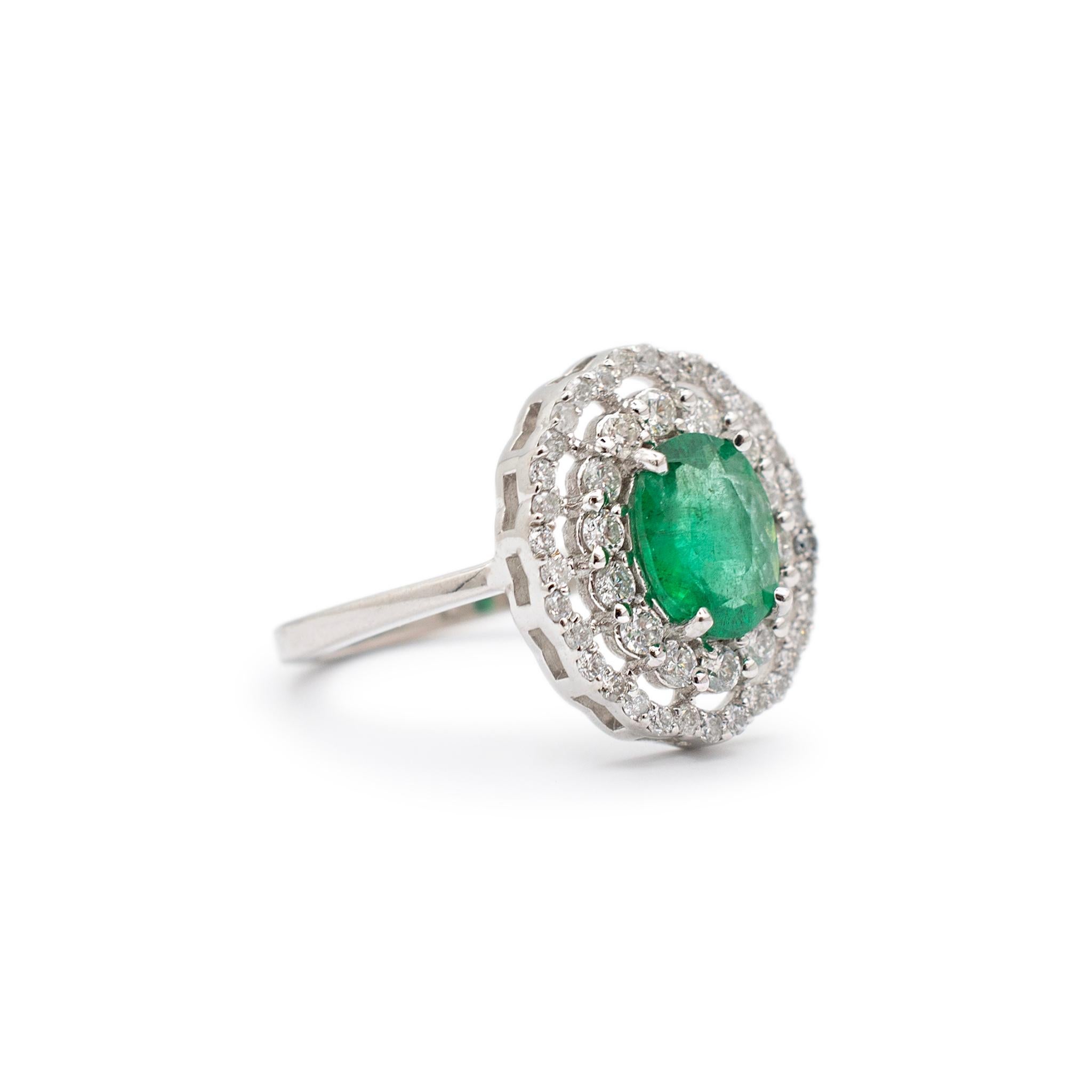 Gender: Ladies

Material Type:18K White Gold

Ring Size: 6.5

Shank width: 2.10mm 

Weight: ﻿4.20 g

Halo Head Measurements: 15.55mm x 13.30mm

Ladies custom made polished rhodium plated 18K white gold, diamond and emerald double-halo, cocktail ring