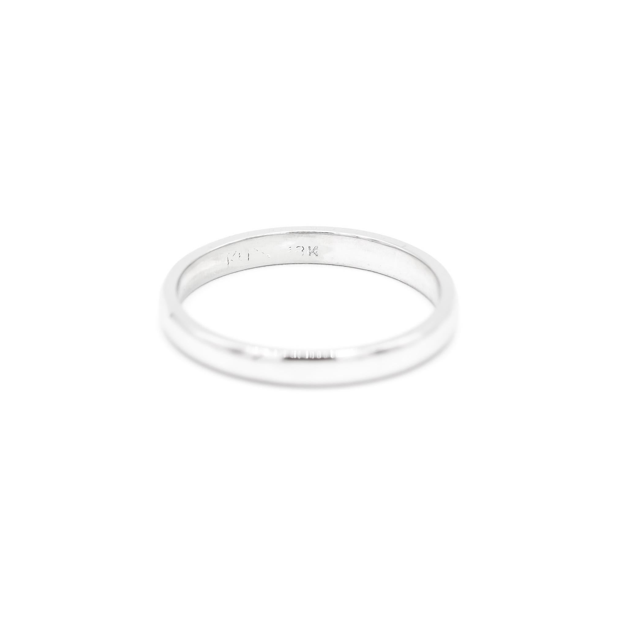 One lady's custom made polished rhodium plated 18K white gold, wedding band with a half-round shank. The band is a size 5.75. The band weighs a total of 2.10 grams. Engraved with 