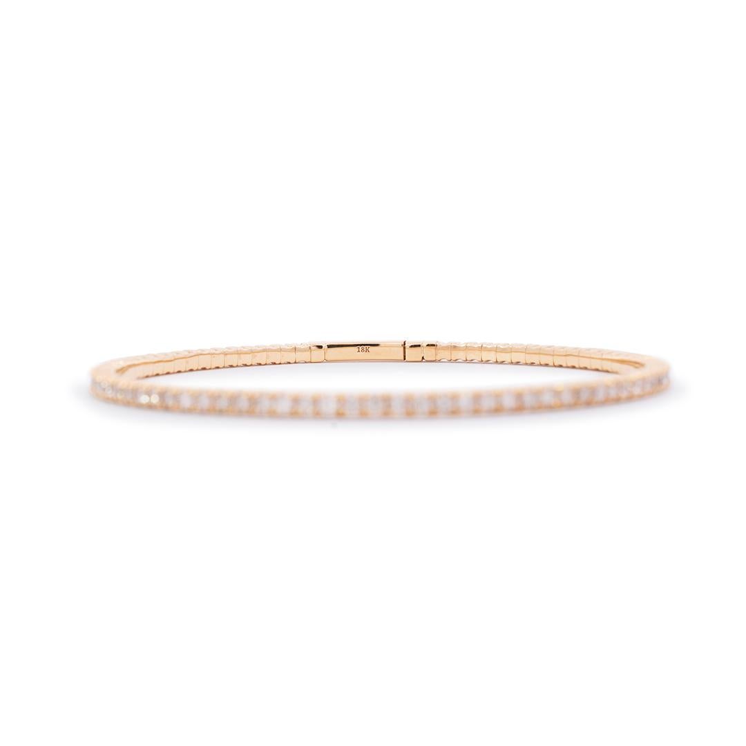Lady's custom made polished 18K yellow gold, diamond bangle, tennis bracelet. The bracelet is 2.50mm thick and measures approximately 6.75 inches in length and weighs a total of 9.86 grams. Engraved with 