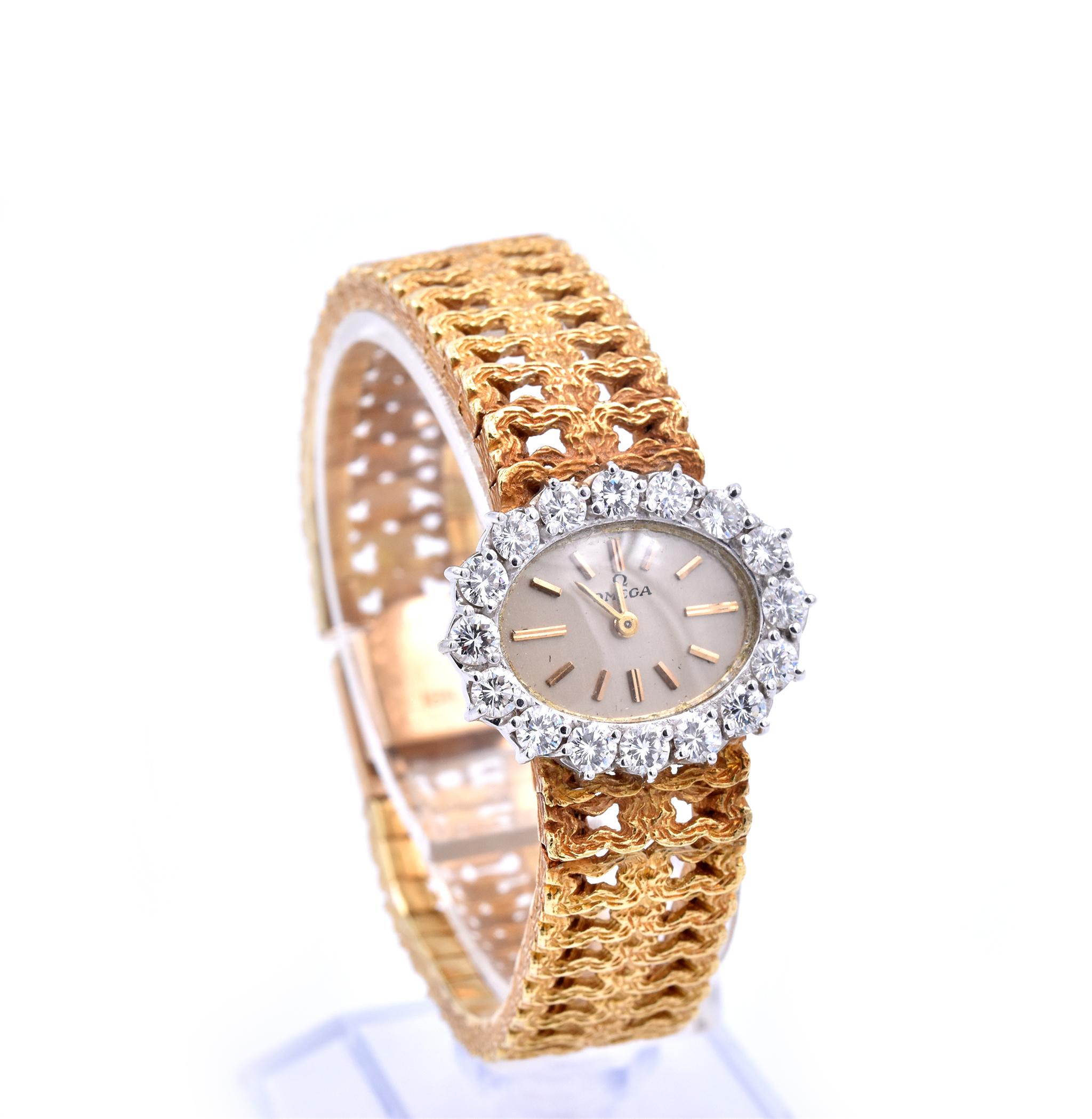 Movement: manual wind 
Function: hours, minutes
Case: 25.5mm x 21mm oval case
Bezel: 16 round brilliant cuts = 2.00cttw
Band: 14.50mm wide 18k yellow gold textured band
Dial: champagne dial with gold stick hour markers, gold hands
Weight: 57.99