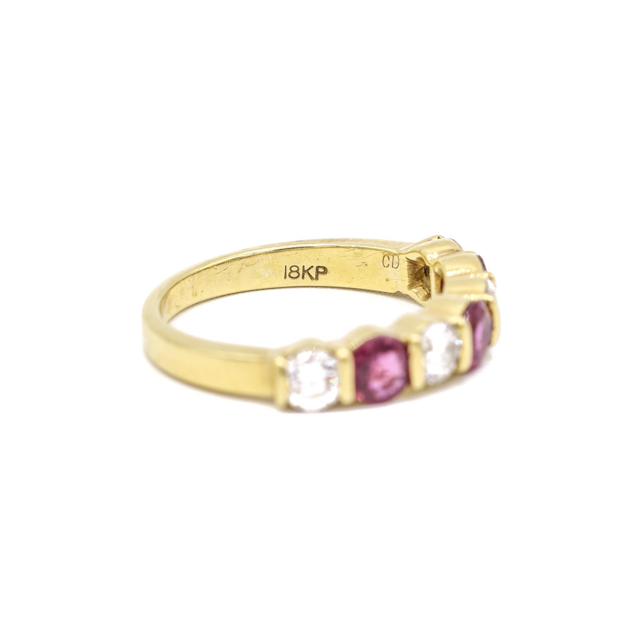 One lady's custom made polished 18K yellow gold seven-across, diamond and ruby vintage, semi-eternity band with a soft-square shank. The band is a size 6.5. The band weighs a total of 4.00 grams. Stamped 