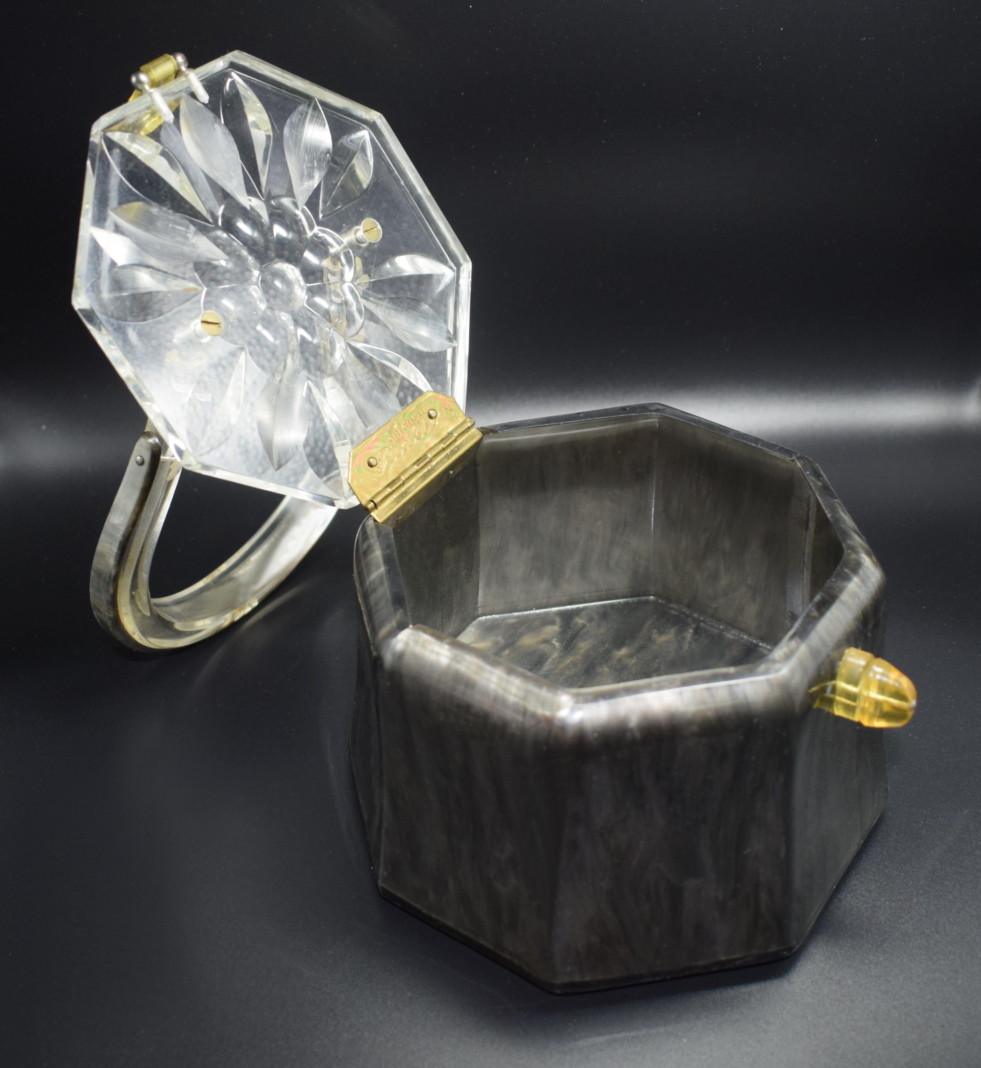 Fabulous 1950s Lucite box bag by Rialto of New York. Deeply carved clear Lucite lid with clear horse shoe shaped solid handle. The body of the bag is marbled grey with a yellow Lucite clasp. Signed on the inside brass hinge 'Original by Rialto'.