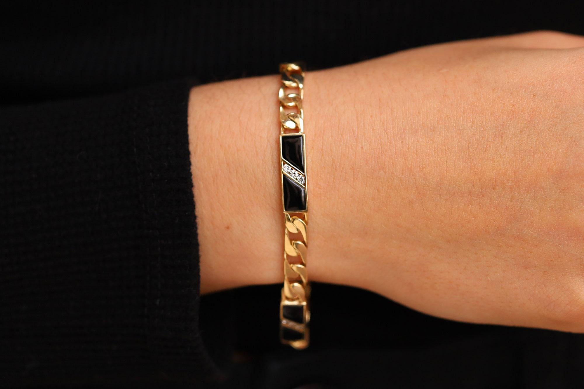 A fabulous find from our Mob Wife estate jewelry collection, this ladies 1980s Cuban link bracelet showcases sleek black onyx and diamond accents. Weighing a substantial 18 grams of 14k yellow gold, this eco friendly, vintage heirloom harkens back