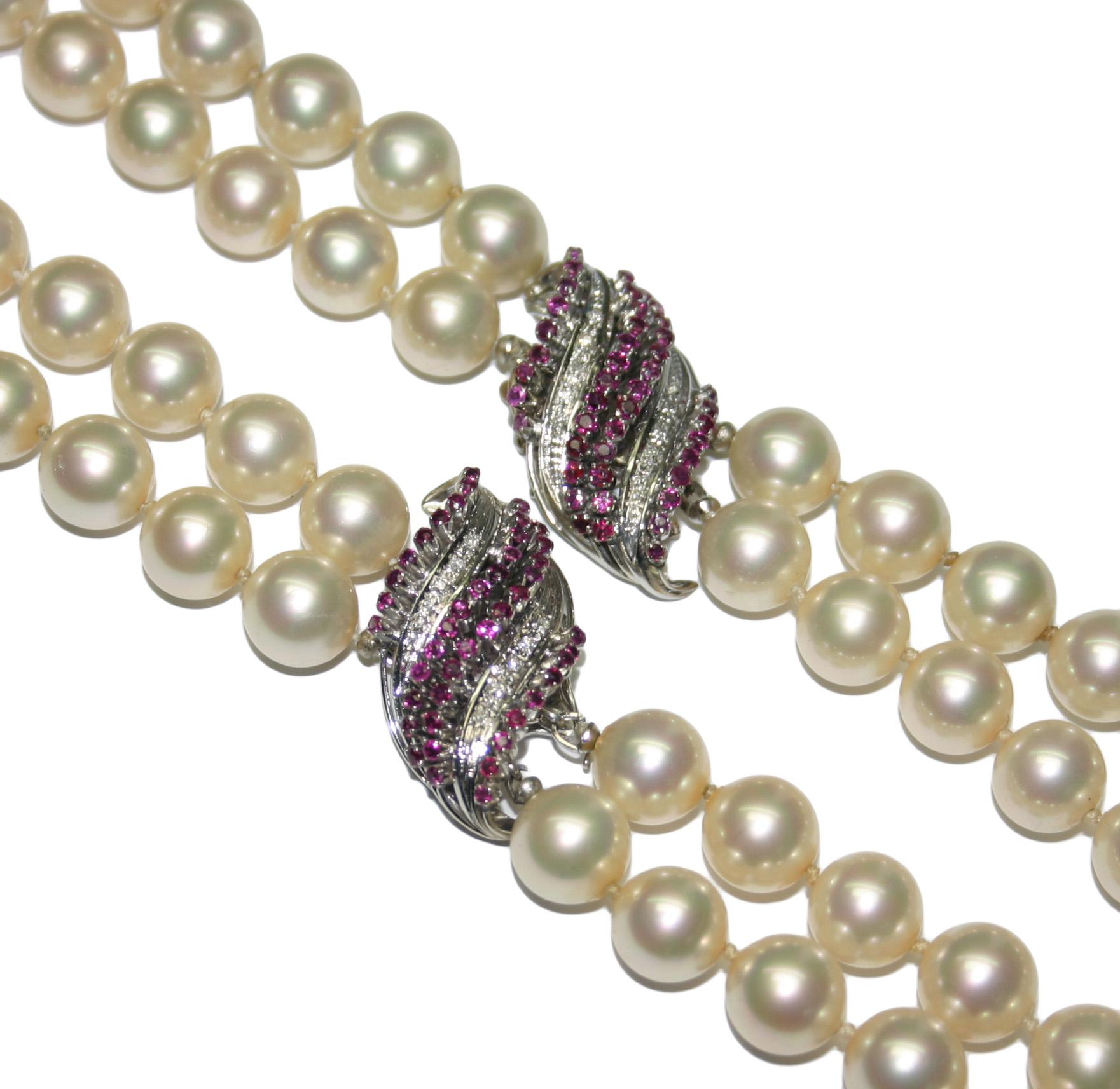 24 inch Faux Double Pearl Strand with 18k White Gold Diamond and Ruby Clasps.

This necklace contains high end faux pearls with 0.50 total carats of diamonds and 2.00 total carats of rubies on each clasp.

This necklace is not marked 18k but tests