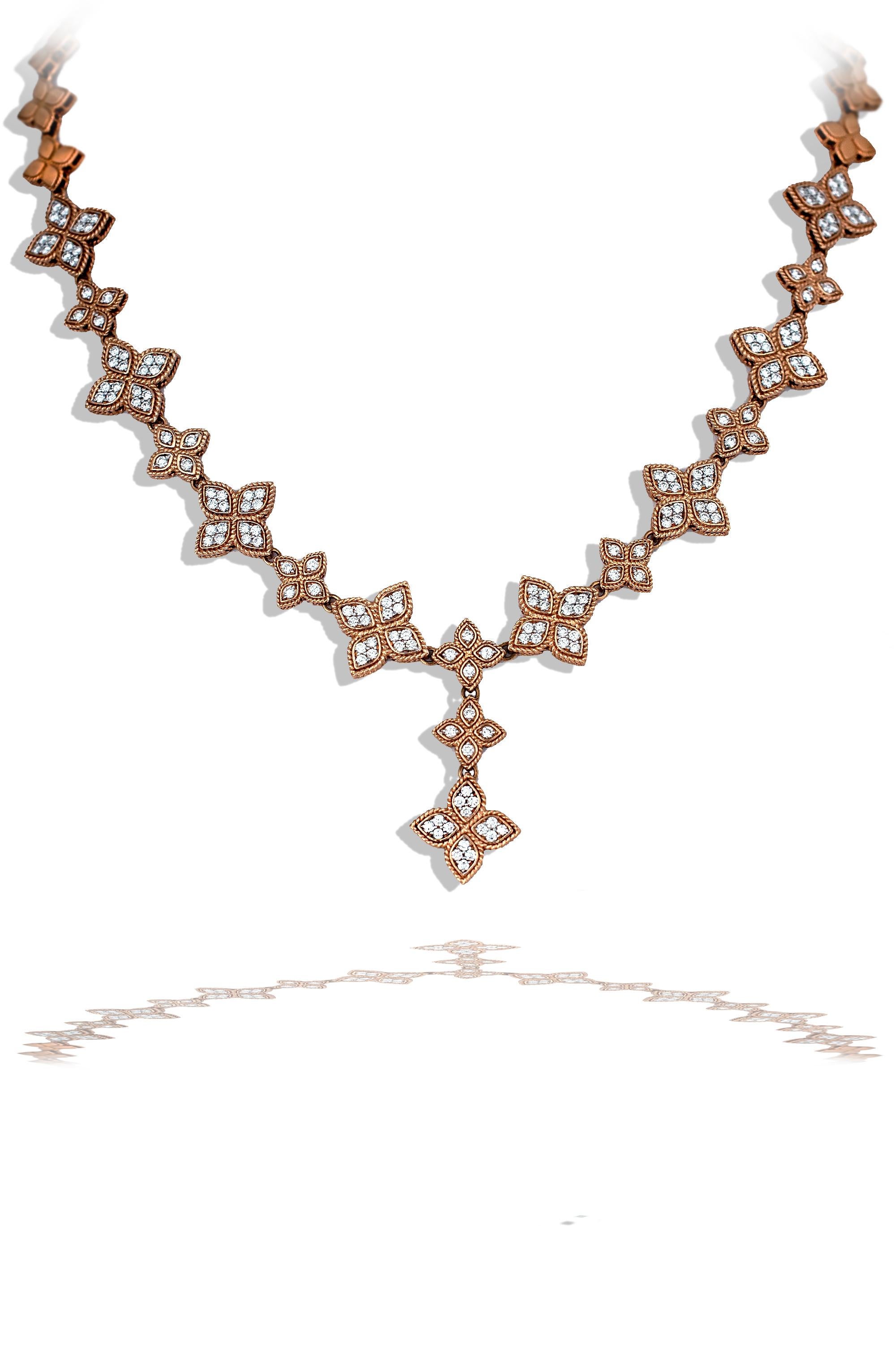 This ladies classic diamond necklace has modern twist on a classic design. This necklace is constructed of 18k rose gold and has seventeen diamond stations.  Each station has an alternating pattern from large to small.  The large stations have