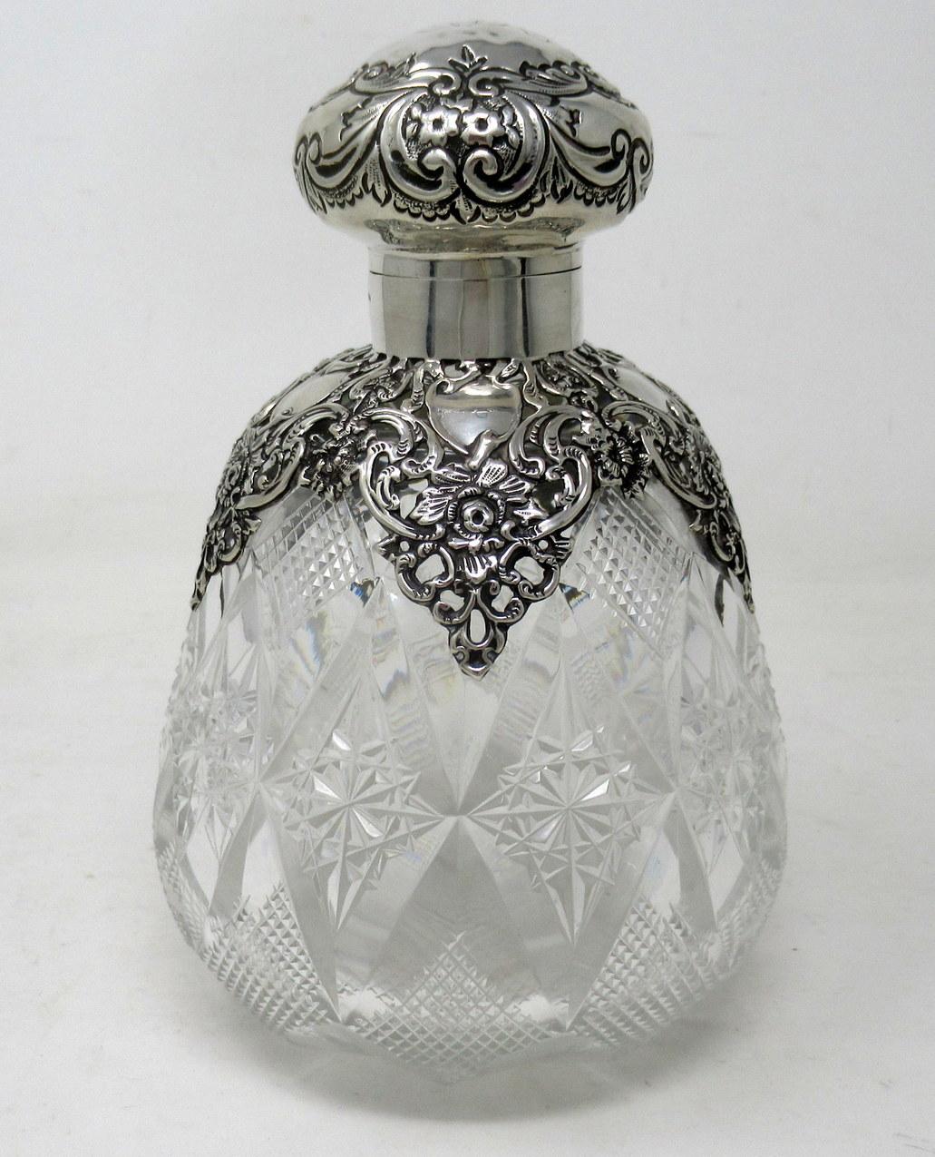 An Exceptionally Fine Quality English full lead hand cut crystal and sterling silver ladies scent bottle of exceptionally large proportions and of outstanding quality, 

The silver gilt hinged lid above a lavish reticulated silver overlay with