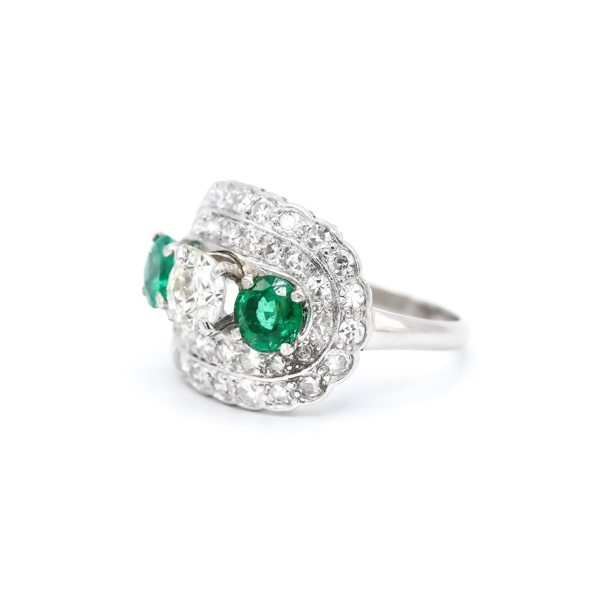 One lady's hand made platinum scattered, diamond and emerald cocktail, antique, art-deco, vintage ring with a half round shank. The ring is a size 6. The ring weighs a total of 5.30 grams., Engraved with 
