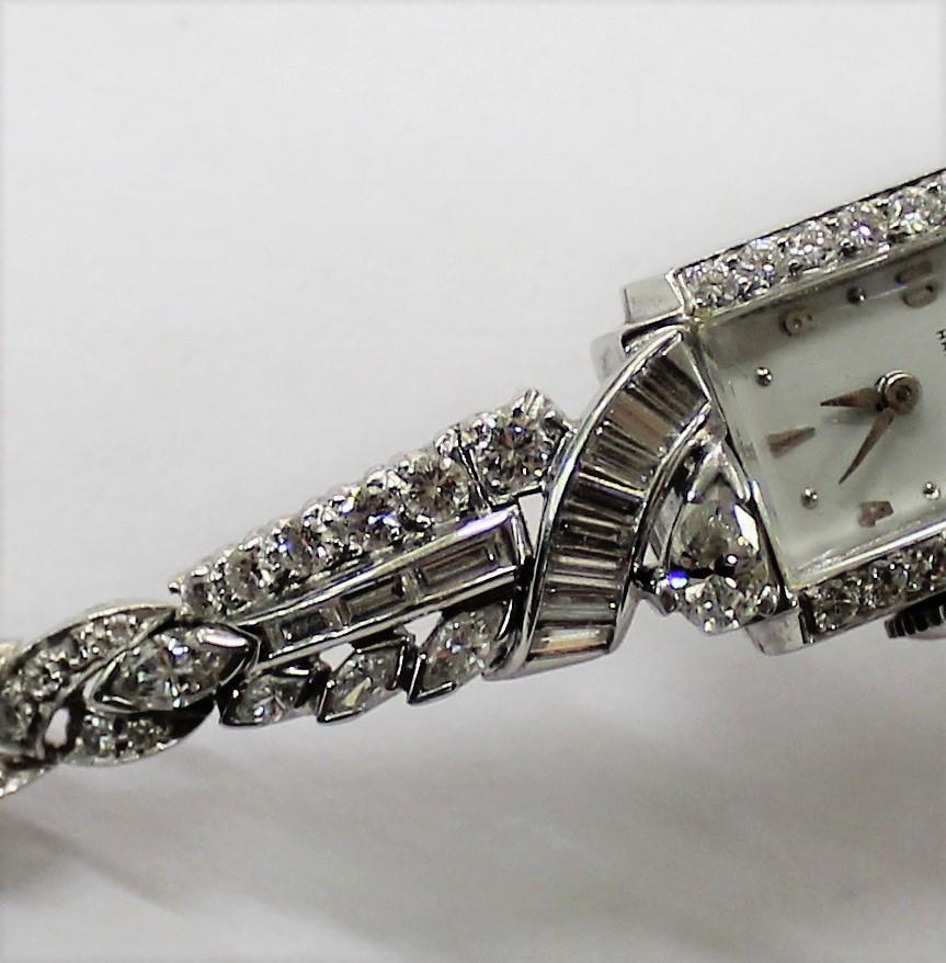 This impressive ladies cocktail watch is from the Art Deco period and is crafted in platinum and diamonds by the Hamilton Watch Co. It features an impressive 4.55 carats of diamonds.

The watch has a bright polish finish, square top, box clasp