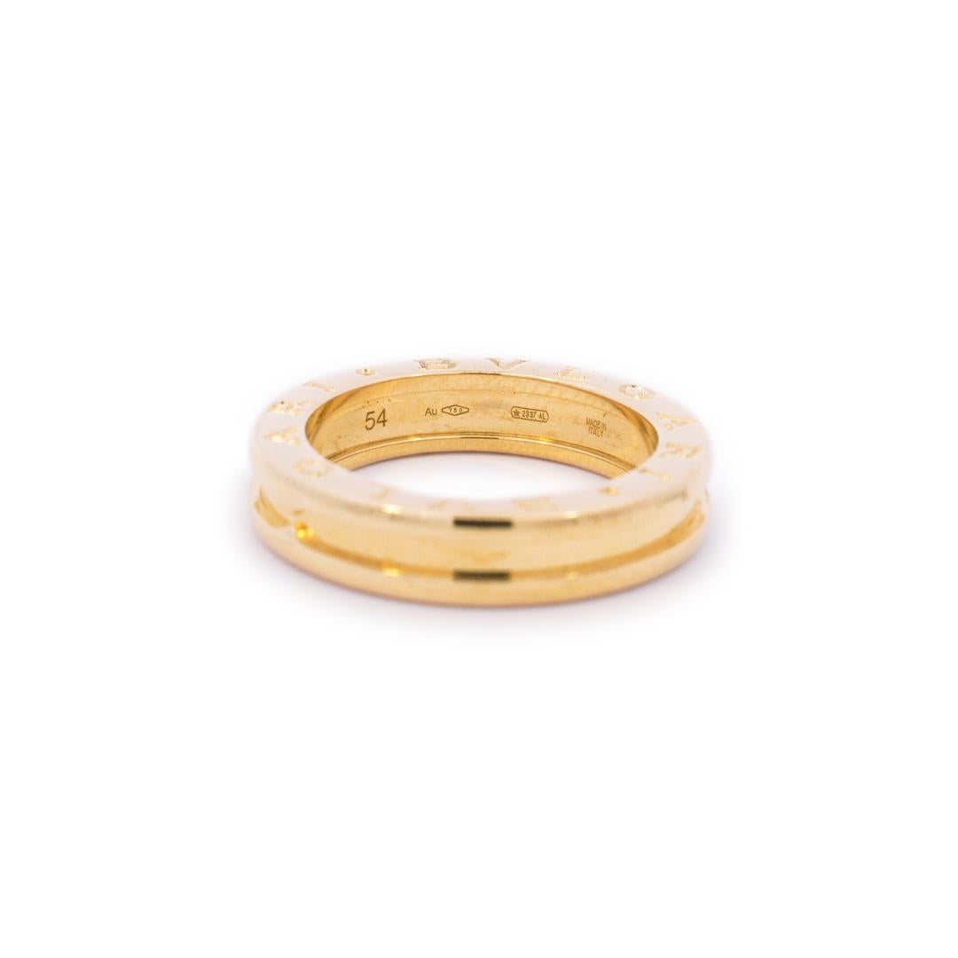 Lady's designer made polished 18K rose gold, wedding band with a tapered shank. The band is a size 7 US or 54 European and is 4.80mm thick. The band weighs a total of 7.43 grams. Engraved with 
