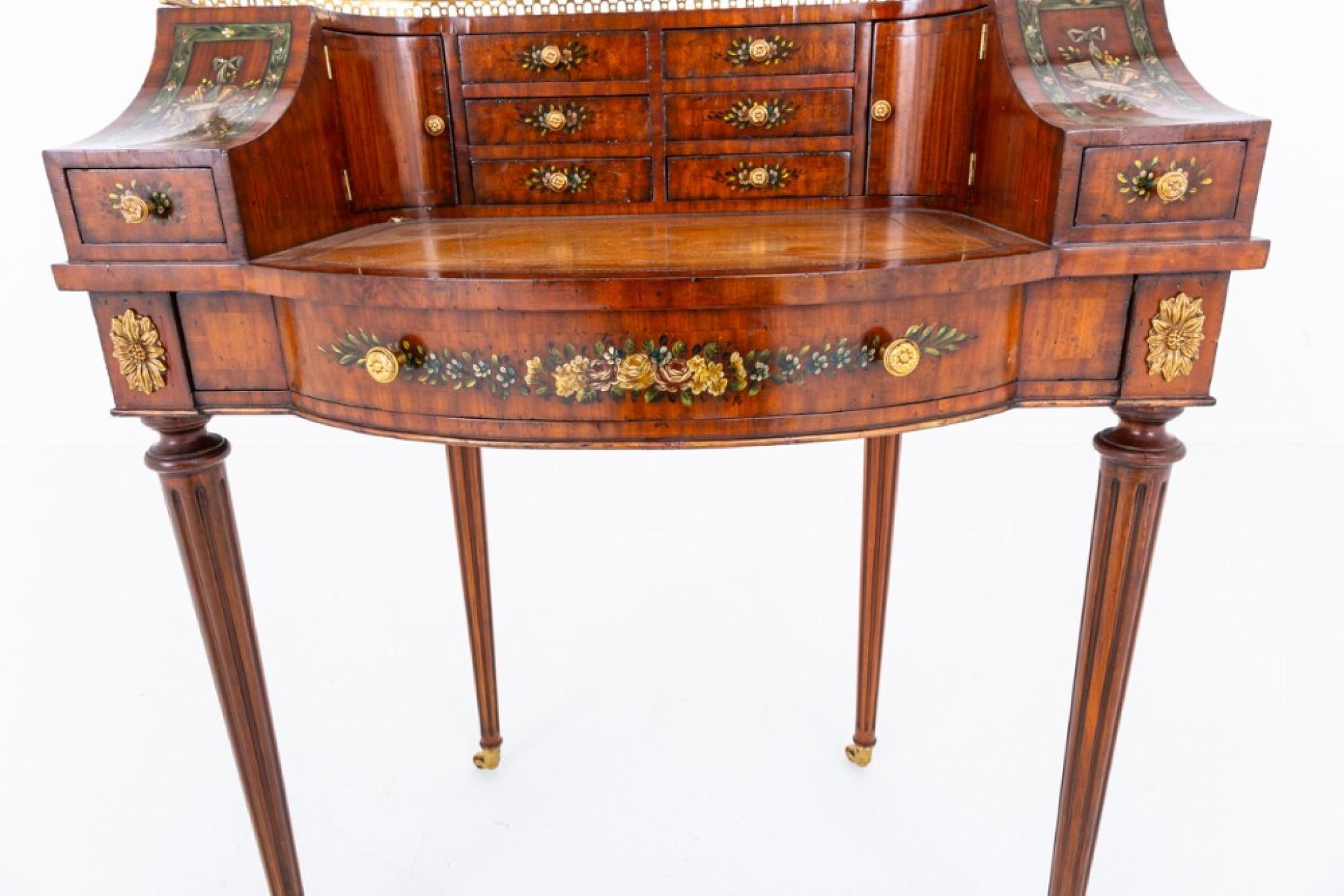 Este bonito escritorio es de tamaño reducido, a la manera de la Regencia
Alrededor de 1920
Sobre patas torneadas y acanaladas con ruedas de latón.
El escritorio dispone de 9 cajones forrados de caoba.
El escritorio tiene decoración pintada, una