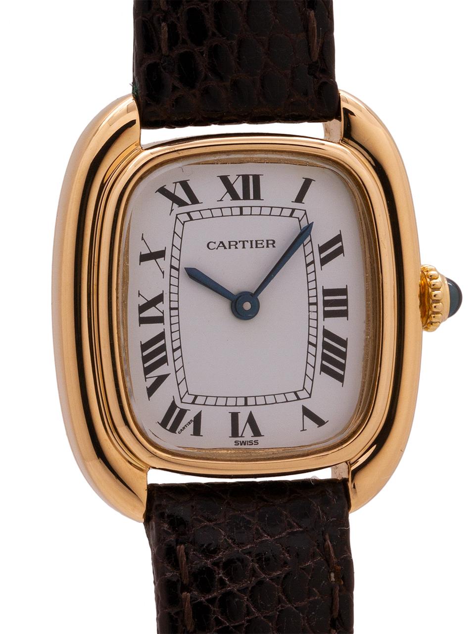 
Vintage lady Cartier Gondola model in 18K YG circa 1070’s. A beautiful lady’s watch measuring 24 X 28mm, in a elongated cushion shaped case. Featuring a pristine condition glossy white dial with Cartier “secret” signature, blued steel hands, and
