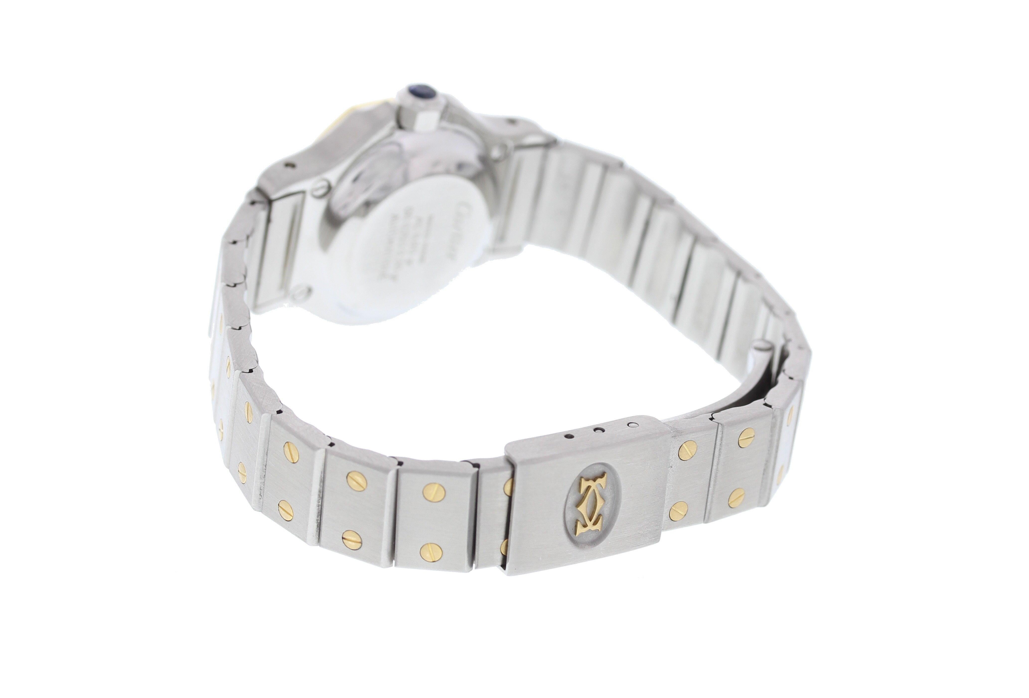 Cartier Santos. 25 mm stainless steel case. 18k yellow gold bezel with custom set diamonds. Blue dial with blue hands and custom set diamond markers. 18k yellow gold and stainless steel band with a yellow gold and stainless steel fold over clasp.