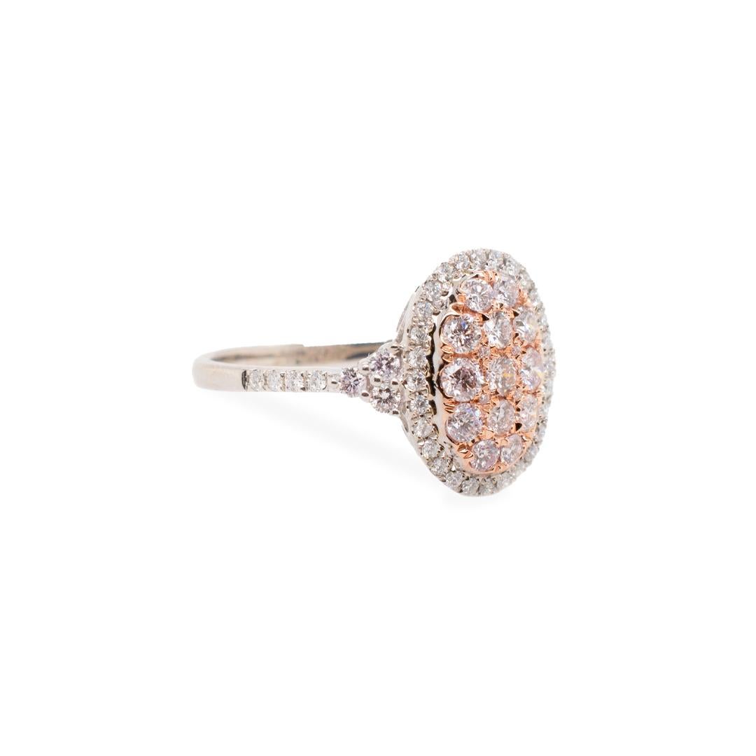 One lady's custom made polished, 14K rose gold and 14K white gold, diamond cluster, halo, cocktail ring with a half round shank. The ring is a size 9 and measures approximately 15.30mm in diameter and weighs a total of 3.60 grams. Stamped 