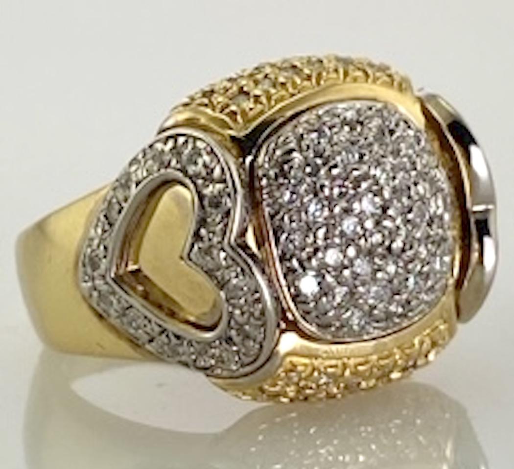 This exquisite lady's  designer style diamond cluster ring is constructed in 14 karat yellow gold and contains .45 carat total weight of diamonds. The dome style top is flanked on the sides by a heart motif. The diamonds are conservatively graded by