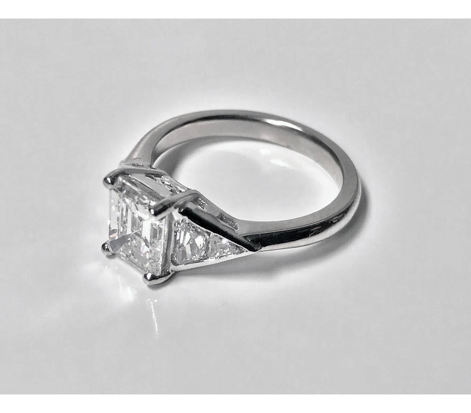 Ladies Diamond Ring mounted in Platinum. The custom hand made Ring set with an , gauging 7.60 x 6.40 x 3.90mm, approximately 1.61 cts, approximately SI1 clarity, approximately G colour, flanked on either side with a triangular and trapeze cut