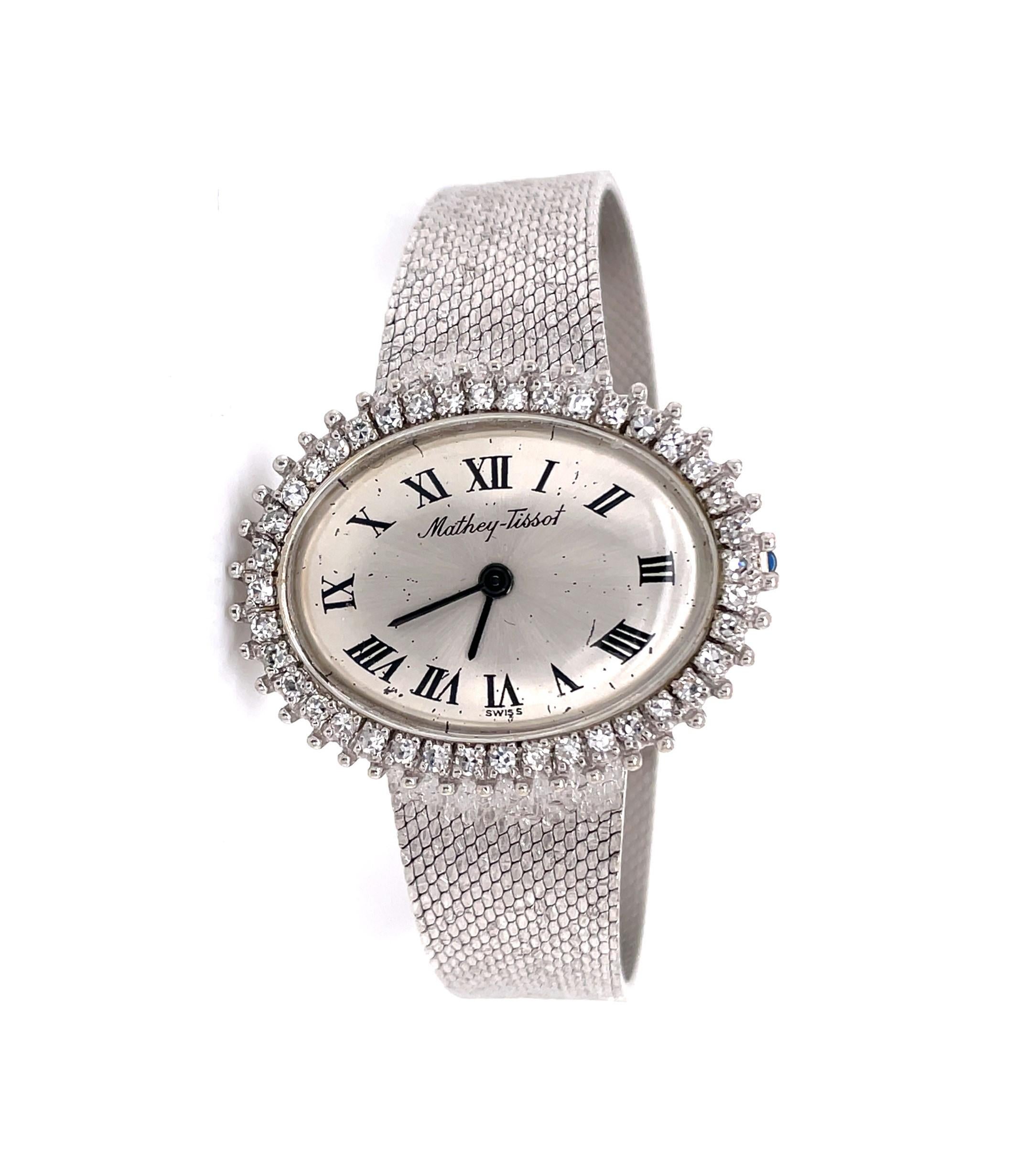 With its stunning diamond framed oval watch dial, this fabulous Mathey-Tissot Dress Watch certainly sparkles with 1.25 carat H/VS diamonds and commands plenty of attention. The fluid high-toned fourteen karat 14k white gold 6-1/2 inch bracelet band