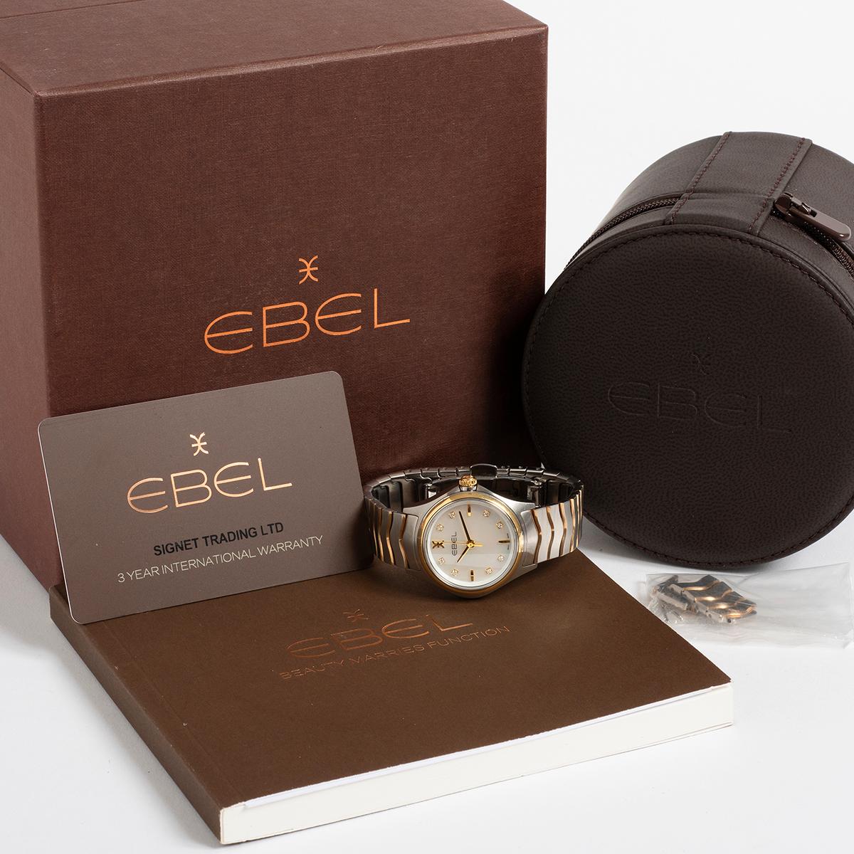 Our classically styled ladies' Ebel Wave reference 011151034 features a 30.0 mm stainless steel case with 18K yellow gold bezel and crown and a stunning mother of pearl dial factory set with 8 diamond indices which we understand equal a combined