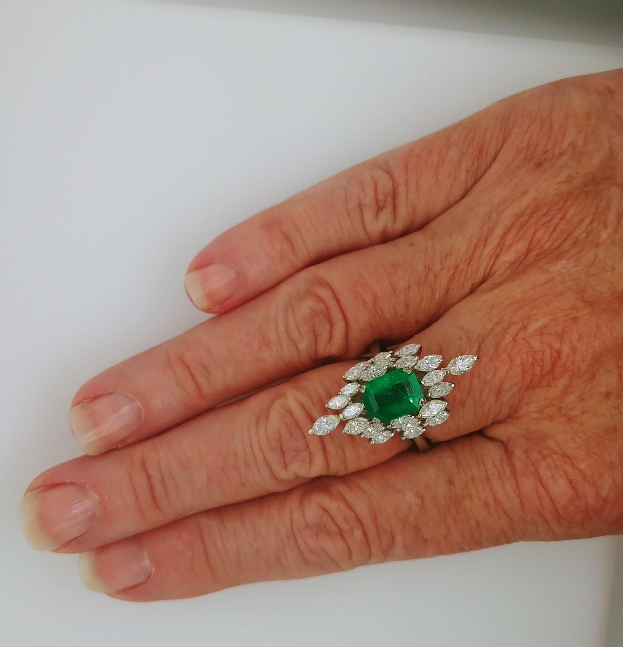 Classy and Elegant Ladies Emerald and Diamond Cocktail Fashion Statement Ring is marquise shaped with a prong set deep green natural emerald cut Emerald measuring 9.15 x 7.14mm and weighing 2.36 carats in the center accentuated by 24 brilliant