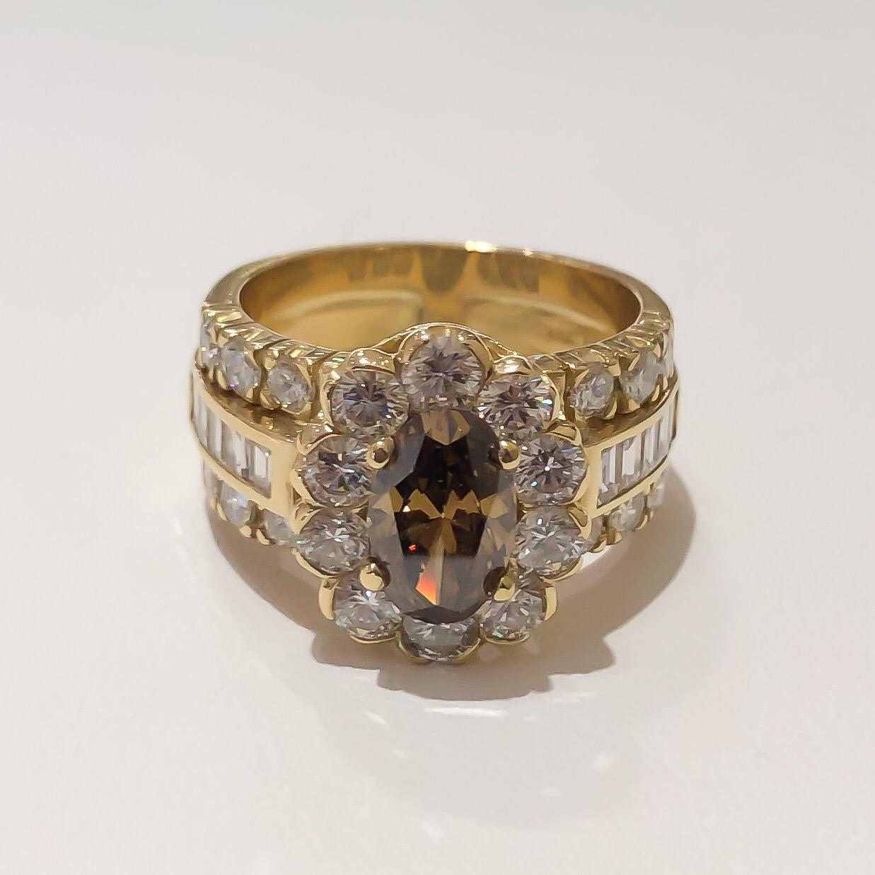 Beautiful handmade custom Fancy Brown Diamond ring designed in solid 18 karat yellow gold. Wide halo ring designed with a stunning cognac brown oval center diamond accented by round brilliant and baguette diamonds. Comes with appraisal and sizable