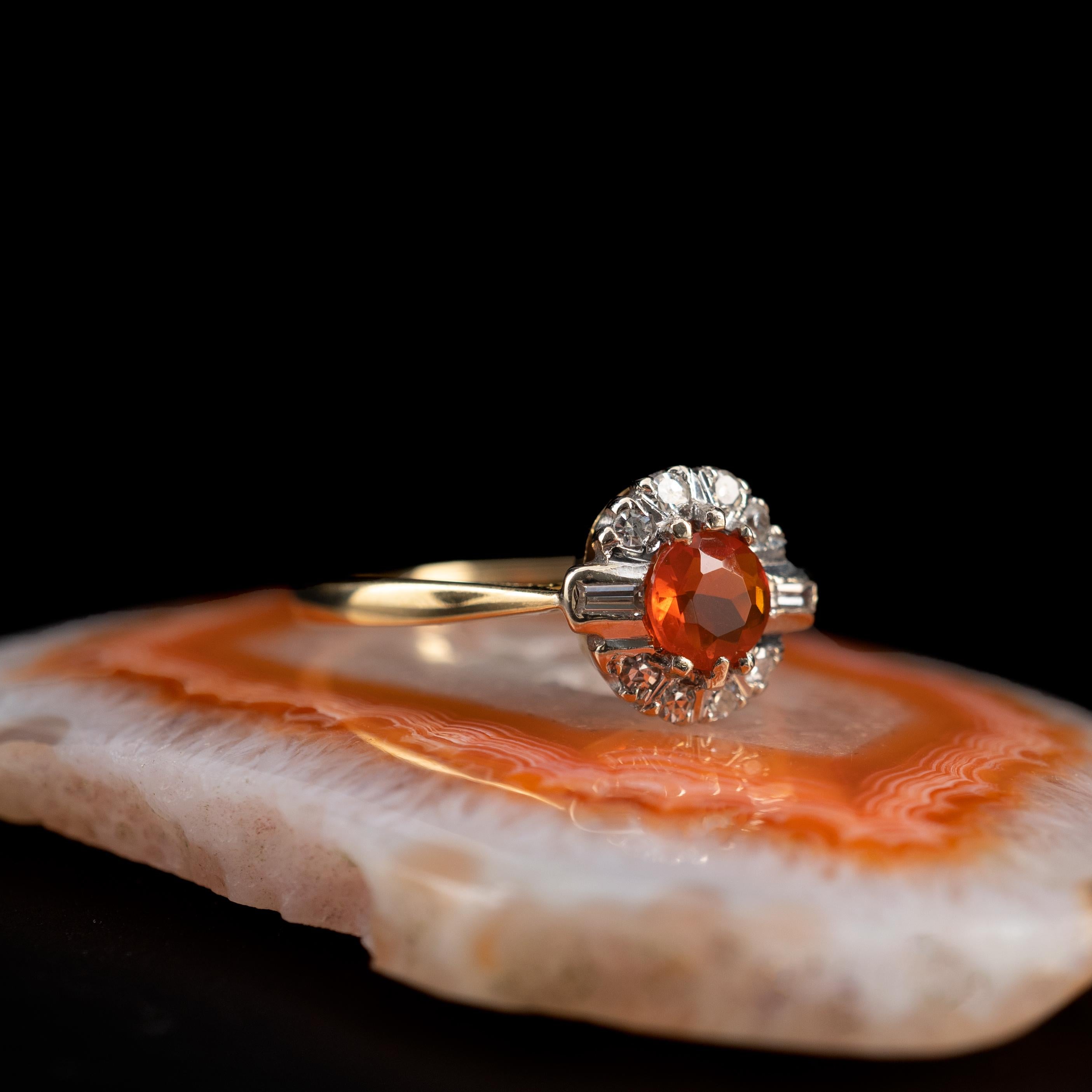 Mexican Fire Opal Diamond Halo Dress Ring 18 Karat Gold - Ring size 7.75

This outstanding ring features a round facet cut stunning fire opal and a halo surround of round-cut and baguette-cut diamonds. The Fire Opal of wonderful colour displaying