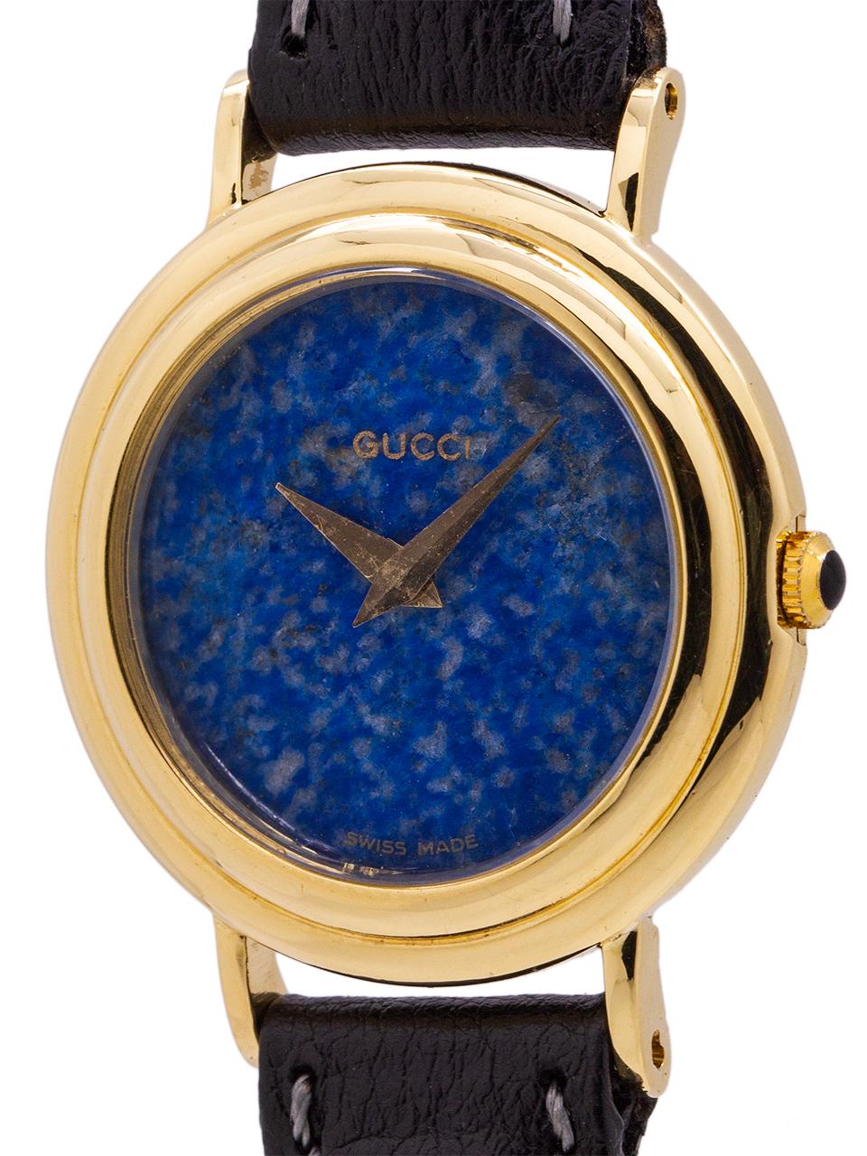 
Seldom seen ladies Gucci watch in 18k yellow gold, with beautiful blue lapis dial, circa 1980’s. Featuring an interesting stepped bezel 25mm case, with black inlaid yellow gold crown. The dial is a beautiful single slab of lapis with only the word