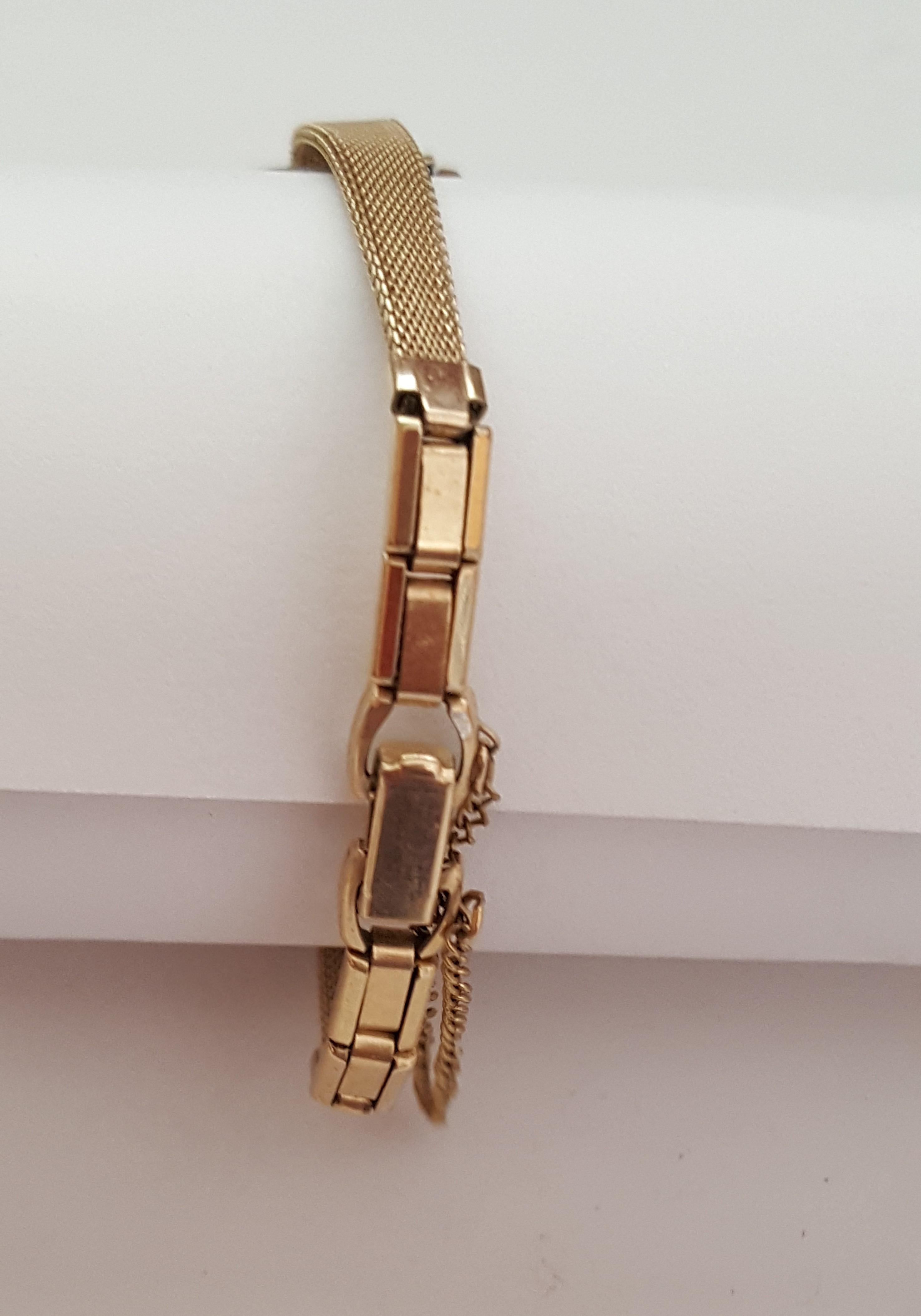 Vintage Ladies Hamilton 24mm Case Gold Plated Watch, Wind Movement Watch, Working, Model 26035-4, 1980's, Round White Face, Black Numerals, Gold, 5 inch bracelet, 10kt gold plated bracelet, with safety chain. Petite band is 5 inches total with fold