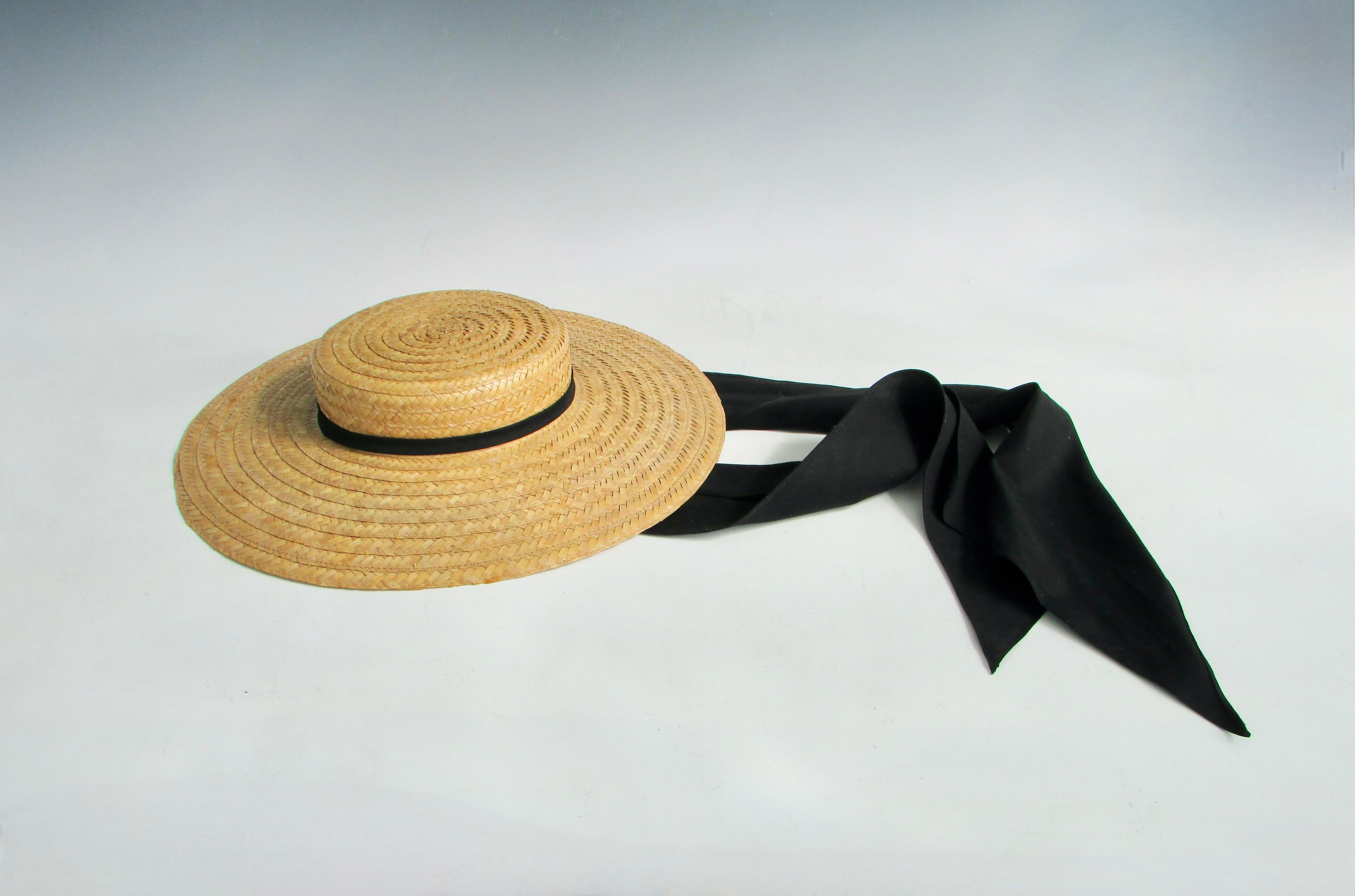 Fine condition probably never worn. Ladies or girls straw hat with black ribbon band and chin tie. Size of opening 6