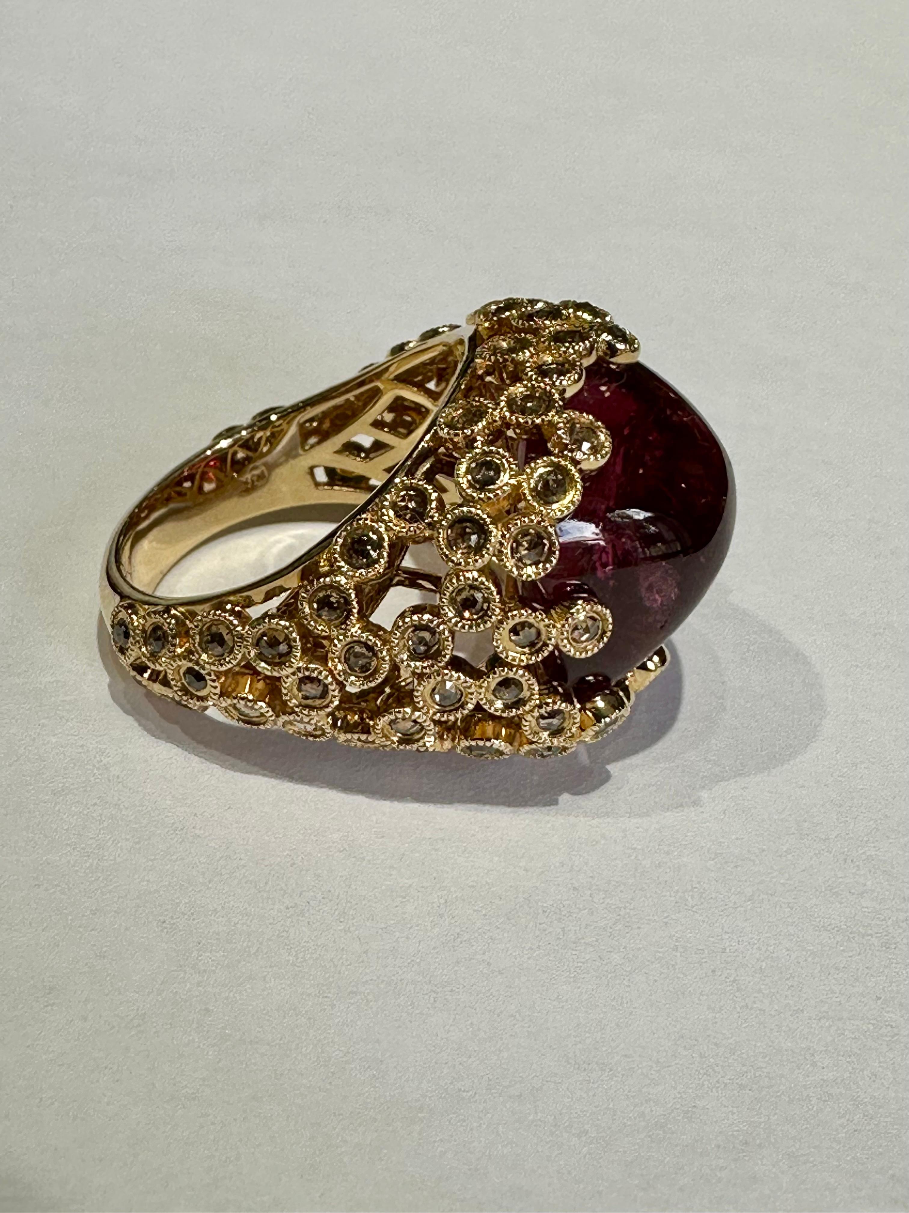 Ladies Hand Made Large Red  Rubellite Sugarloaf Cabochon 18.38 CT and Cognac Diamonds 2.00 Ct 

Ring 14K Yellow Gold.

Description / Condition: New. All jewelry has been professionally scrutinized and cleaned prior to being offered for sale.