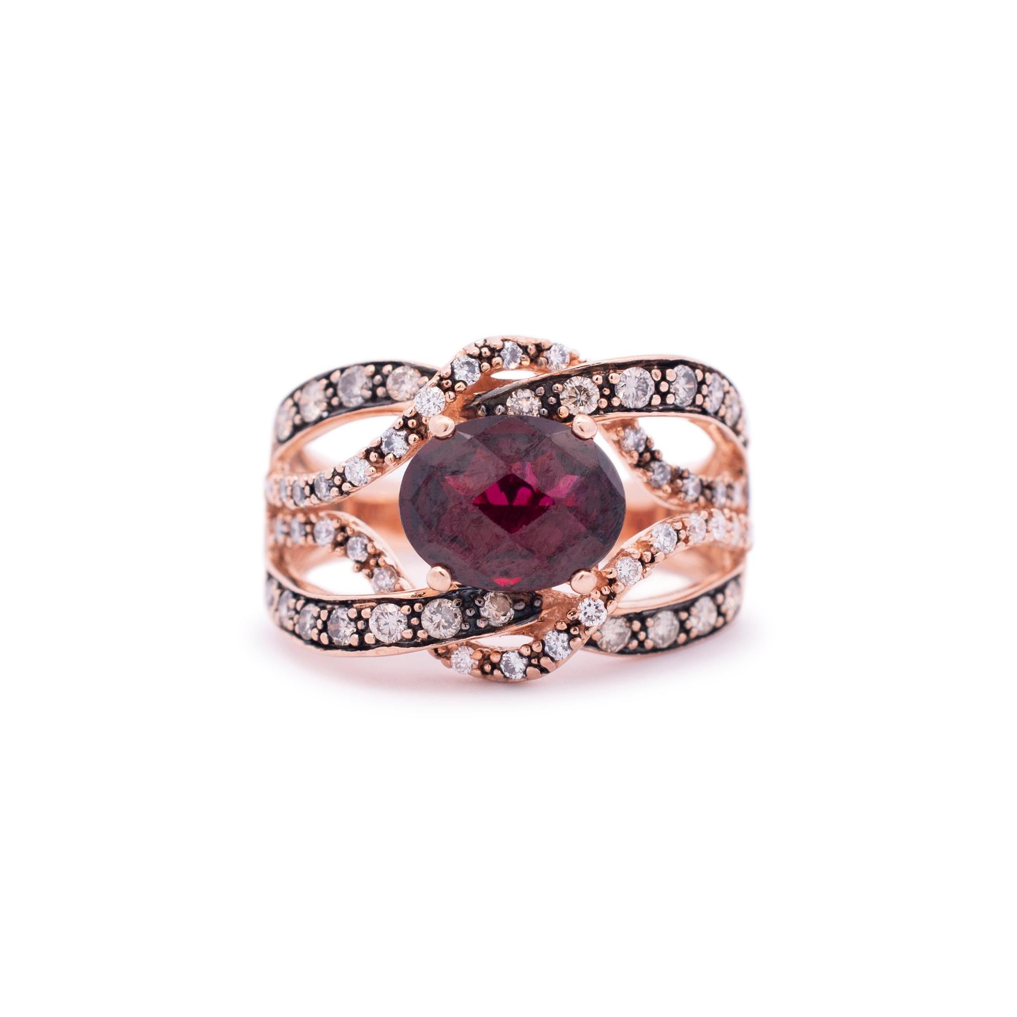 Gender: Ladies

Metal Type: 14K Rose Gold

Size: 6.5

Shank Width: 14.05mm tapering to 2.95mm

Weight: 6.41 Grams

Ladies 14K rose gold diamond and garnet cocktail ring with a soft-square shank. Engraved with 