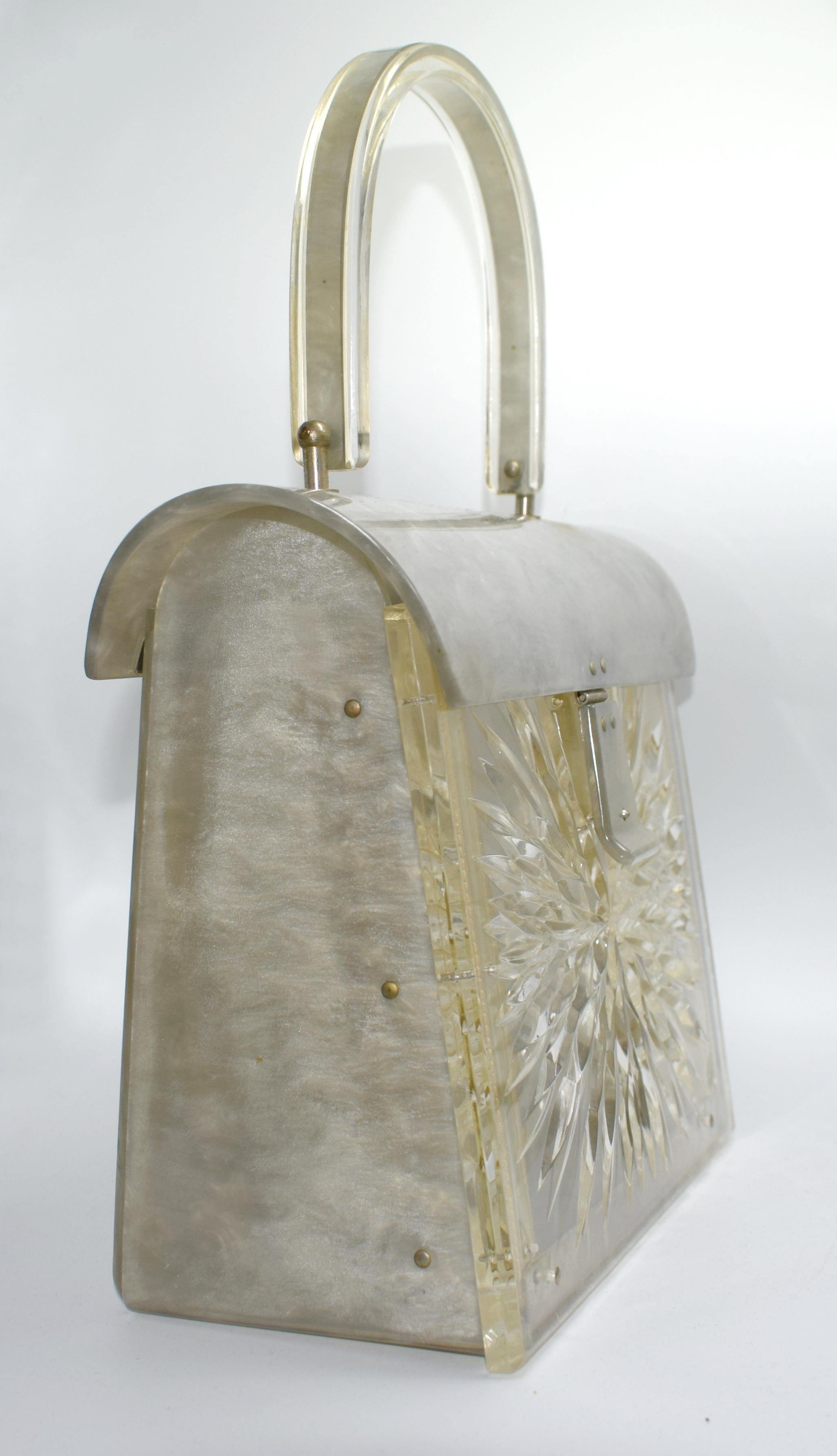 Gilli of New York (marked on hinge) 1950s Lucite box bag with heavily carved front panel with single carrying handle. The domed lid opens to reveal a generously sized interior with an extending front panel to give easier access. A great vintage