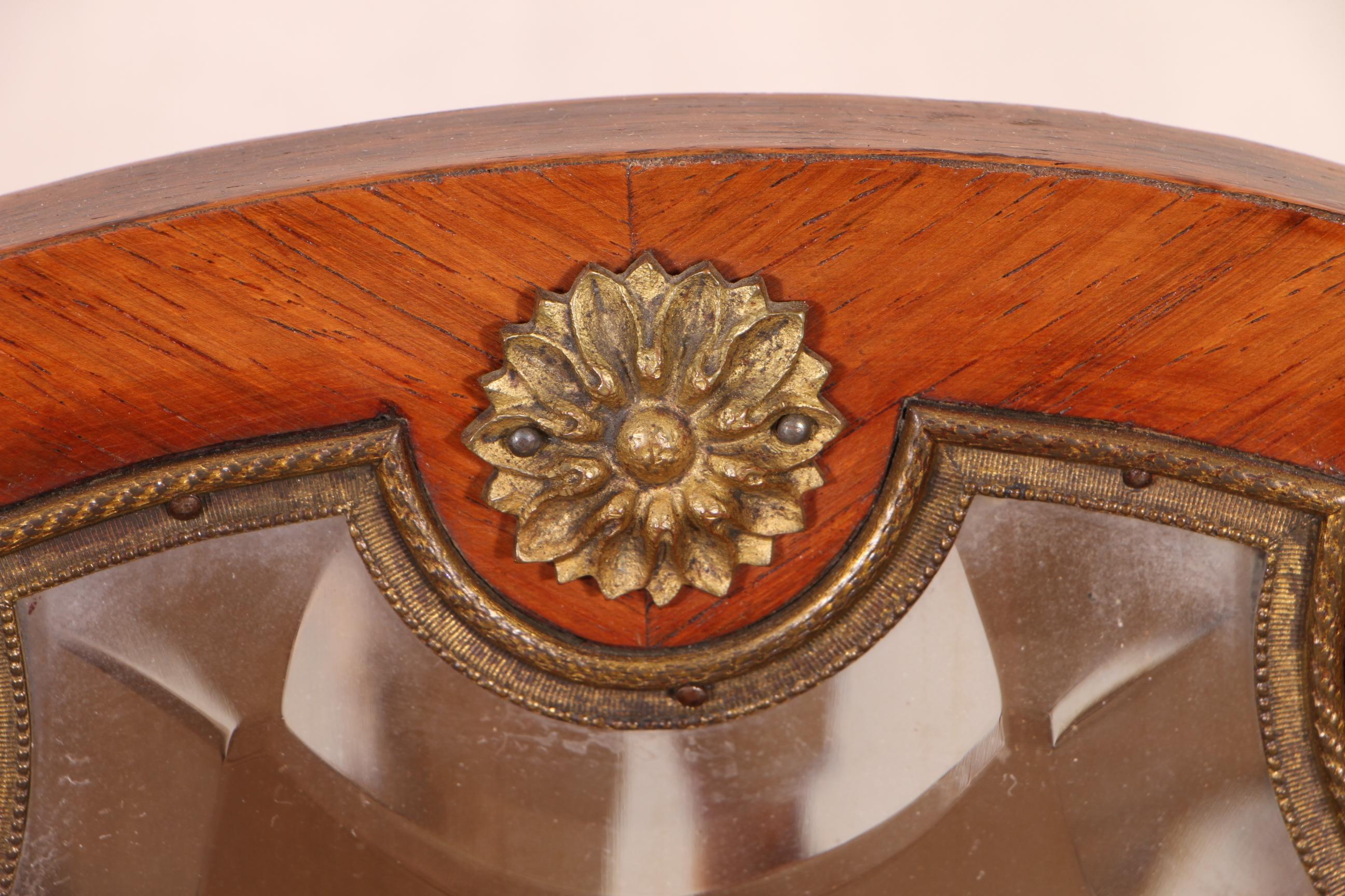 Ladies' marquetry day table, mahogany with parquetry construction. An elaborately shaped top with two brackets flanking the shaped mirror. Two projecting double marquetry drawers with half openwork brass galleries on the sides, mounted on the shaped