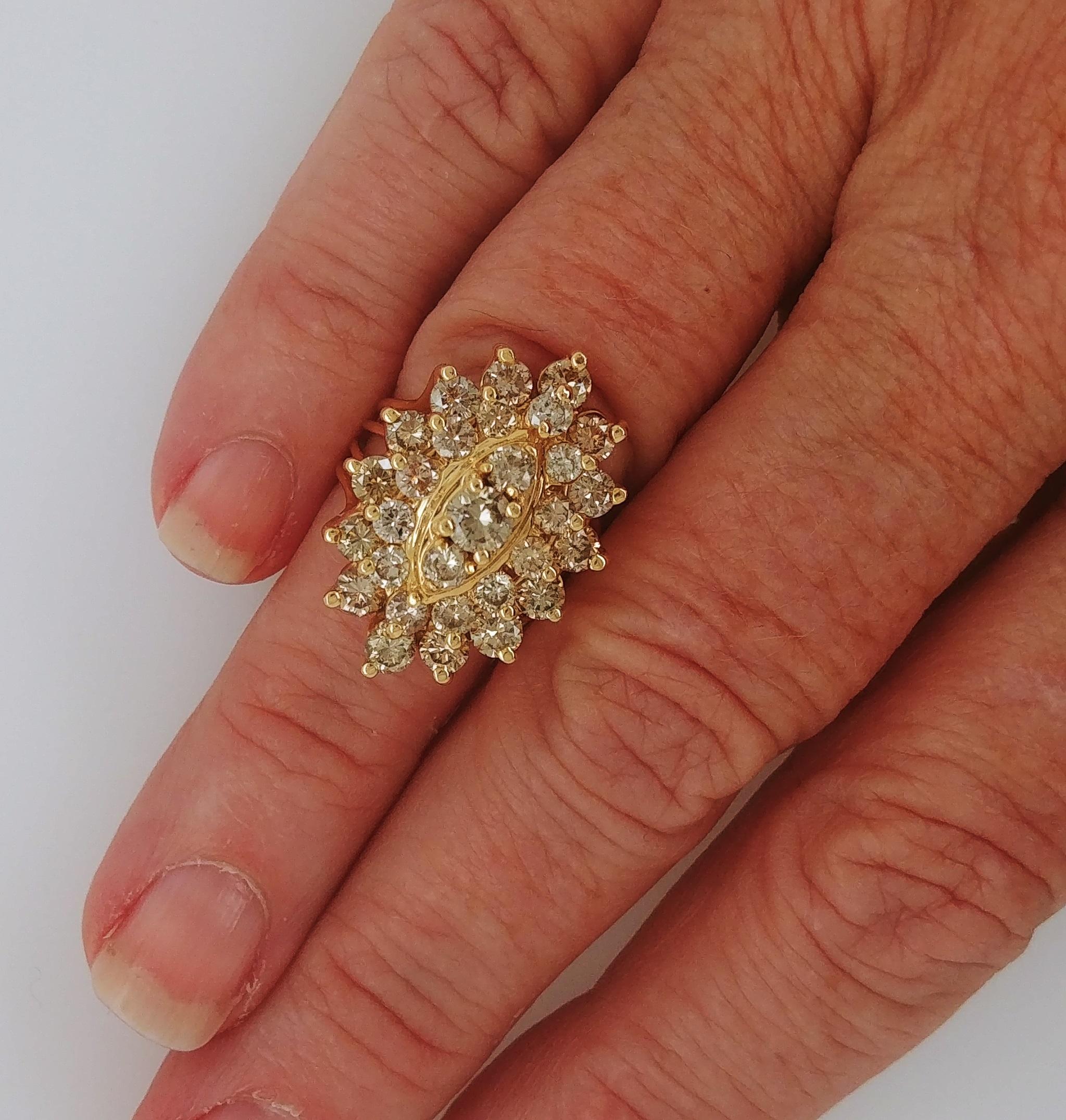 Ladies Marquise Shaped Round Diamonds Cluster Fashion Ring stamped 14K in Yellow Gold weighs 17.7 grams and features 3 tiers of prong set round brilliant cut diamonds with an estimated 2 carats total weight. Ring is almost one inch in length