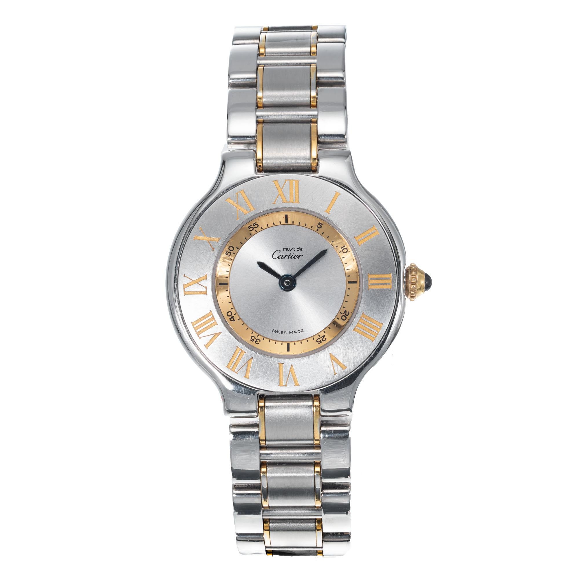 Ladies Must De Cartier wristwatch in steel and 18k gold plate. Cartier Quartz movement.

61.4 grams 
Steel & 18k gold plate 
Band length: 7 inches – can be shortened 
Length: 31mm 
Width: 28mm 
Band width at case: 14mm 
Case thickness: 5.35mm