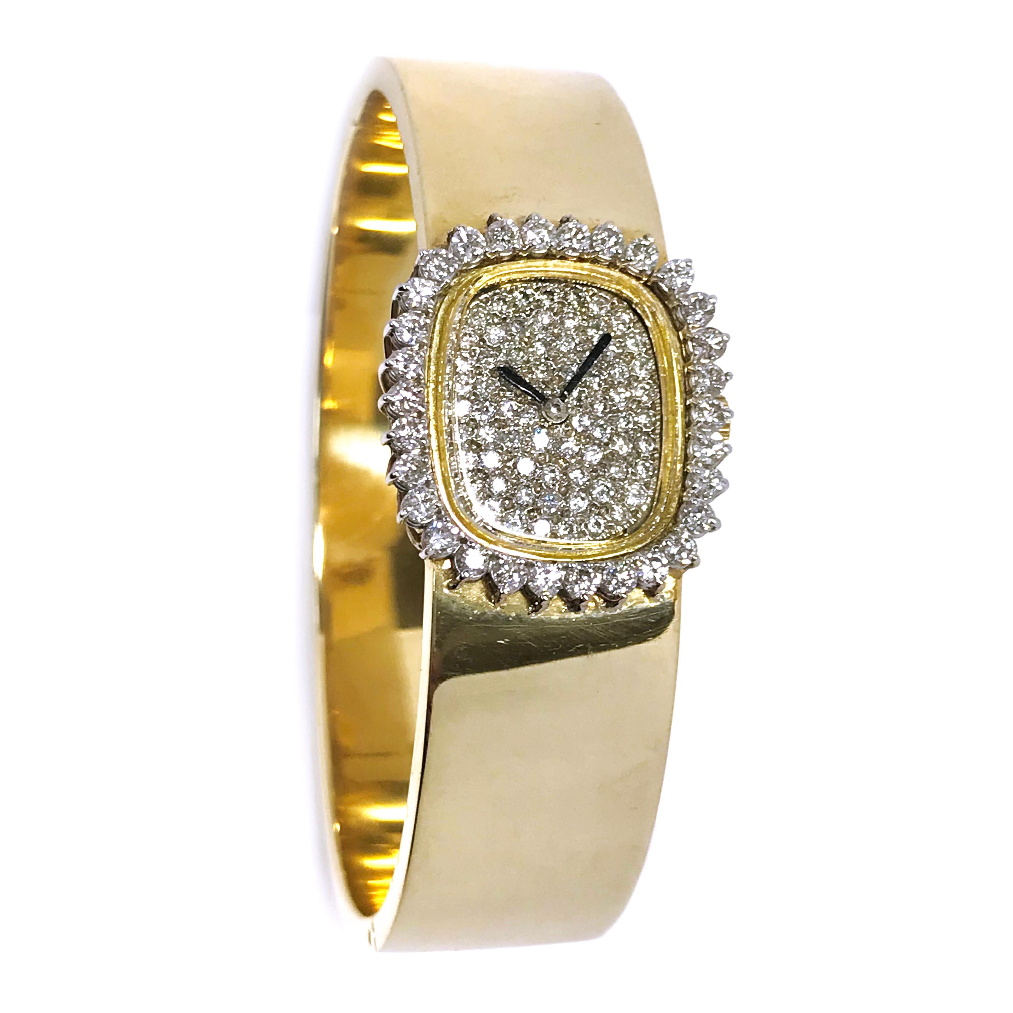 Ladies Italian 14 Karat Diamond Bangle Watch. The case is 18 Karat and the bangle bracelet 14 Karat. This gorgeous timepiece features thirty prong-set round diamonds on the bezel and seventy-five round diamonds pave-set on the dial. The dial has