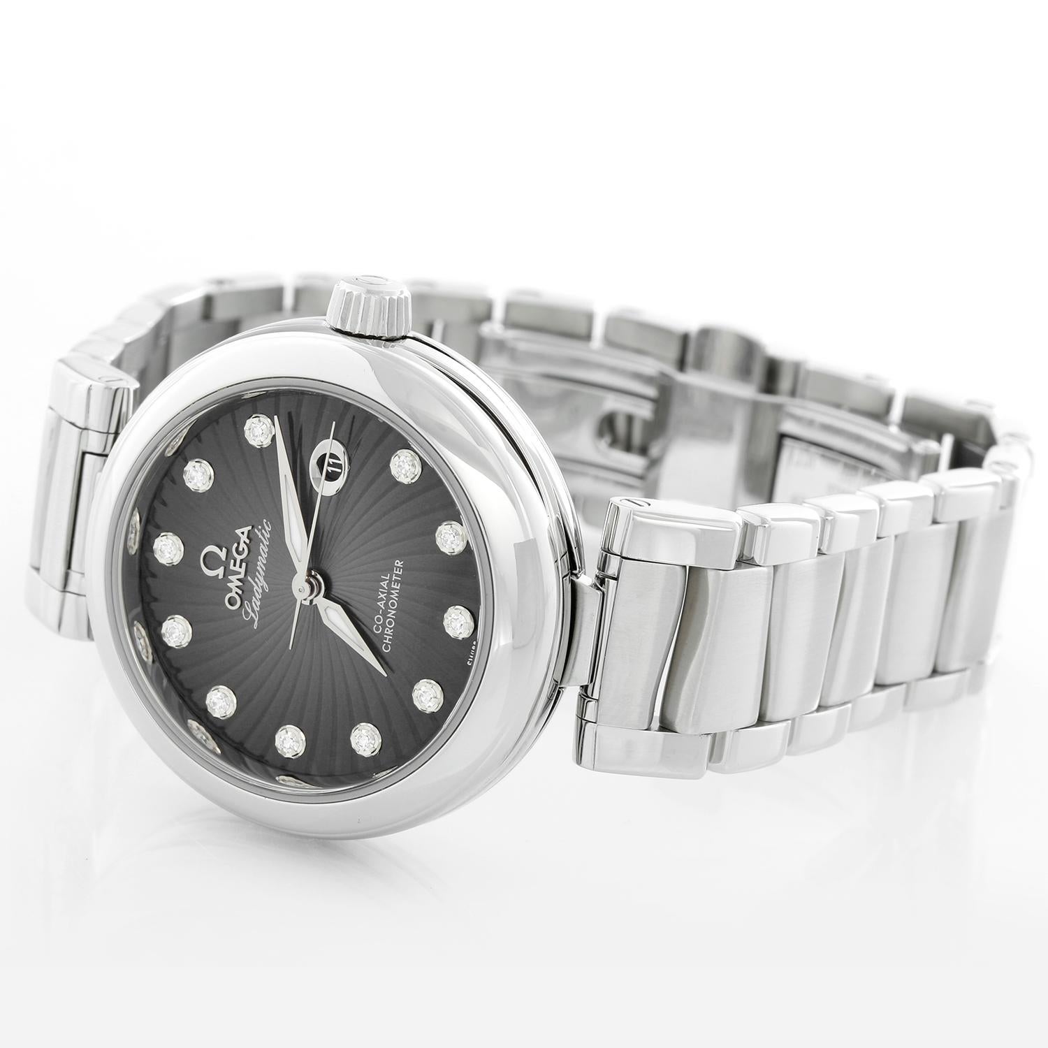 Ladies Omega  Stainless Steel DeVille Ladymatic Watch - Automatic. Stainless Steel case ( 36 mm ). Black dial with Diamond hour markers;  Date at 3 O'Clock. Stainless steel bracelet with an adjustable 6 inch wrist bracelet. Pre-owned with custom box.
