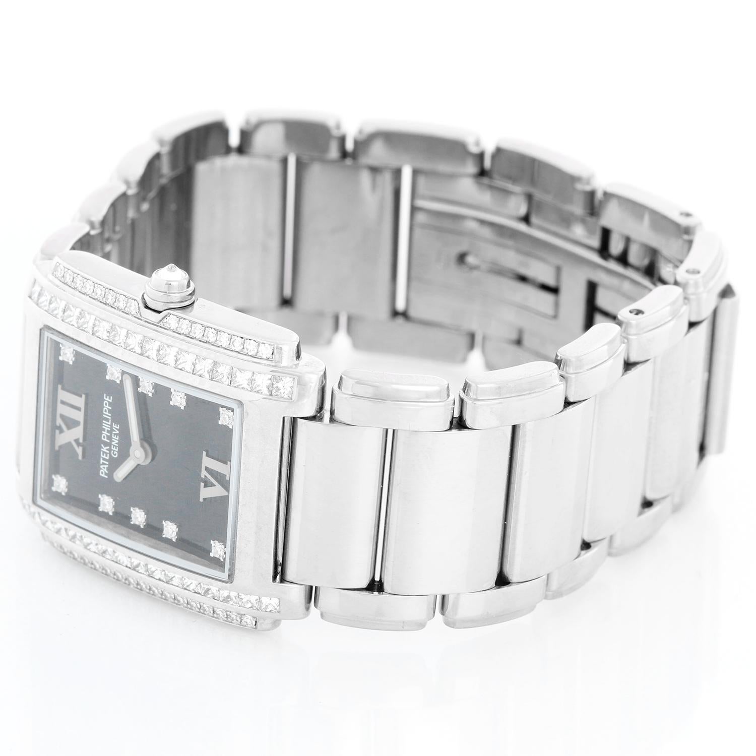 Ladies Patek Philippe Twenty-4 18k White Gold & Diamond Watch 4910/20G - Quartz. 18k white gold case with 2-row diamond bezel (25mm x 30mm). Black dial with diamond markers and Roman numerals at 12 & 6. 18k white gold Patek Philippe link bracelet;